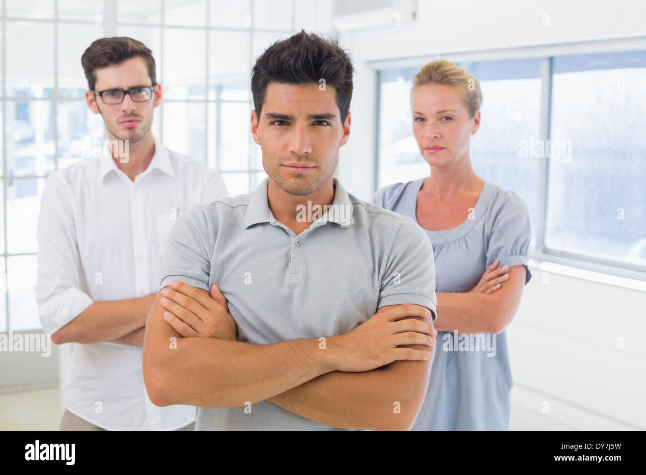 Casual business team looking at camera with arms crossed Stock Photo ...