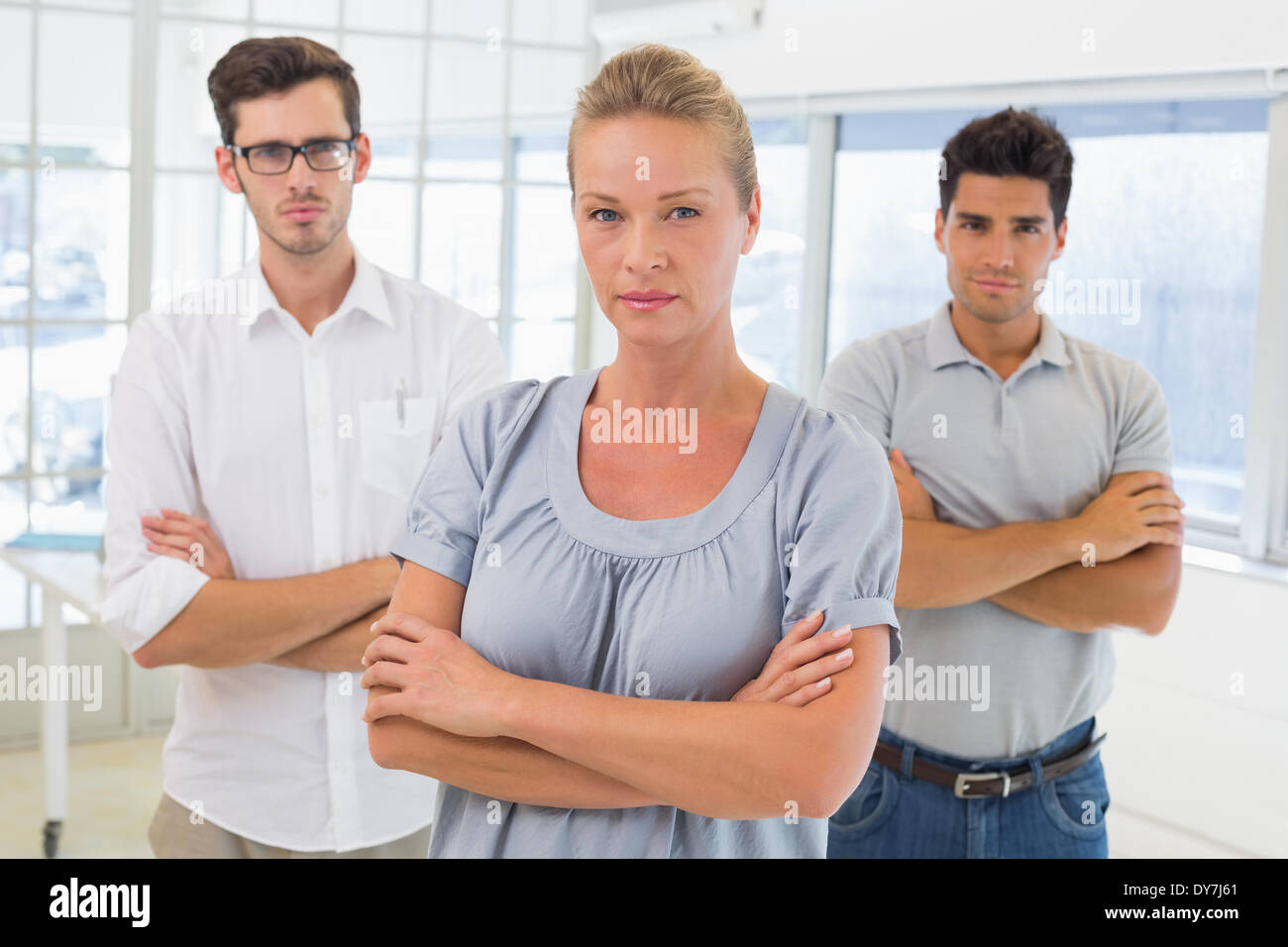 Casual business team looking at camera with arms crossed Stock Photo ...