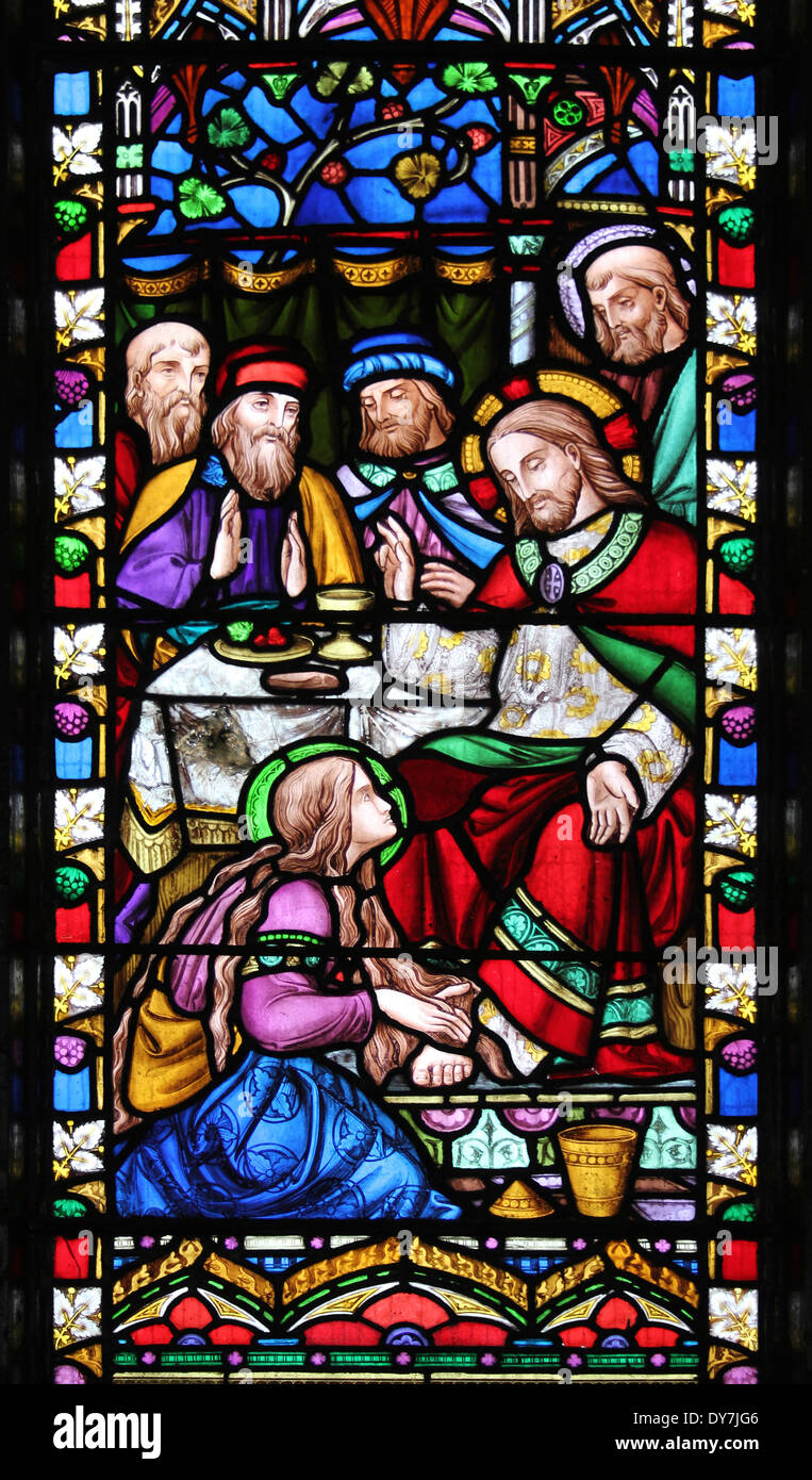 Stained Glass Window Panel Showing Mary, sister of Lazarus Greasing The Feet Of Jesus and Wiped His Feet Dry With Her Hair Stock Photo