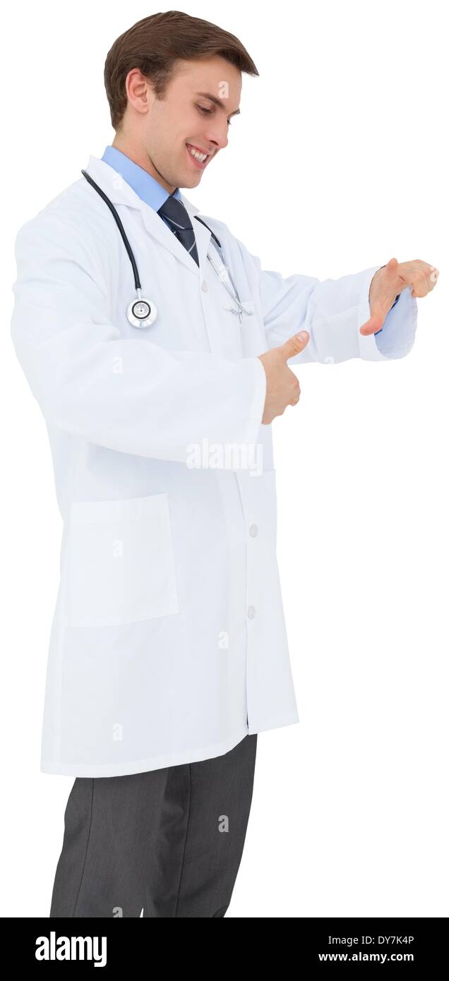 Young doctor in lab coat gesturing Stock Photo
