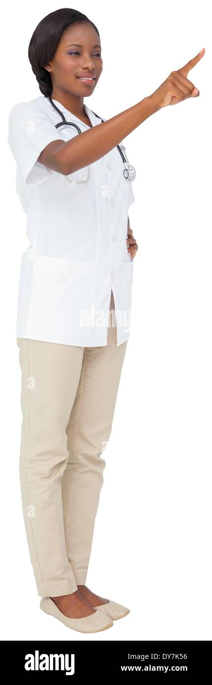 Young nurse in tunic pointing Stock Photo