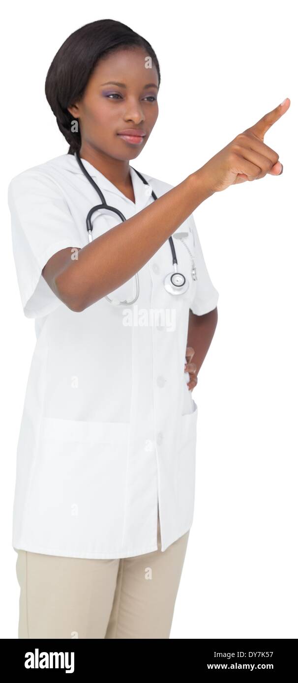 Young nurse in tunic pointing Stock Photo