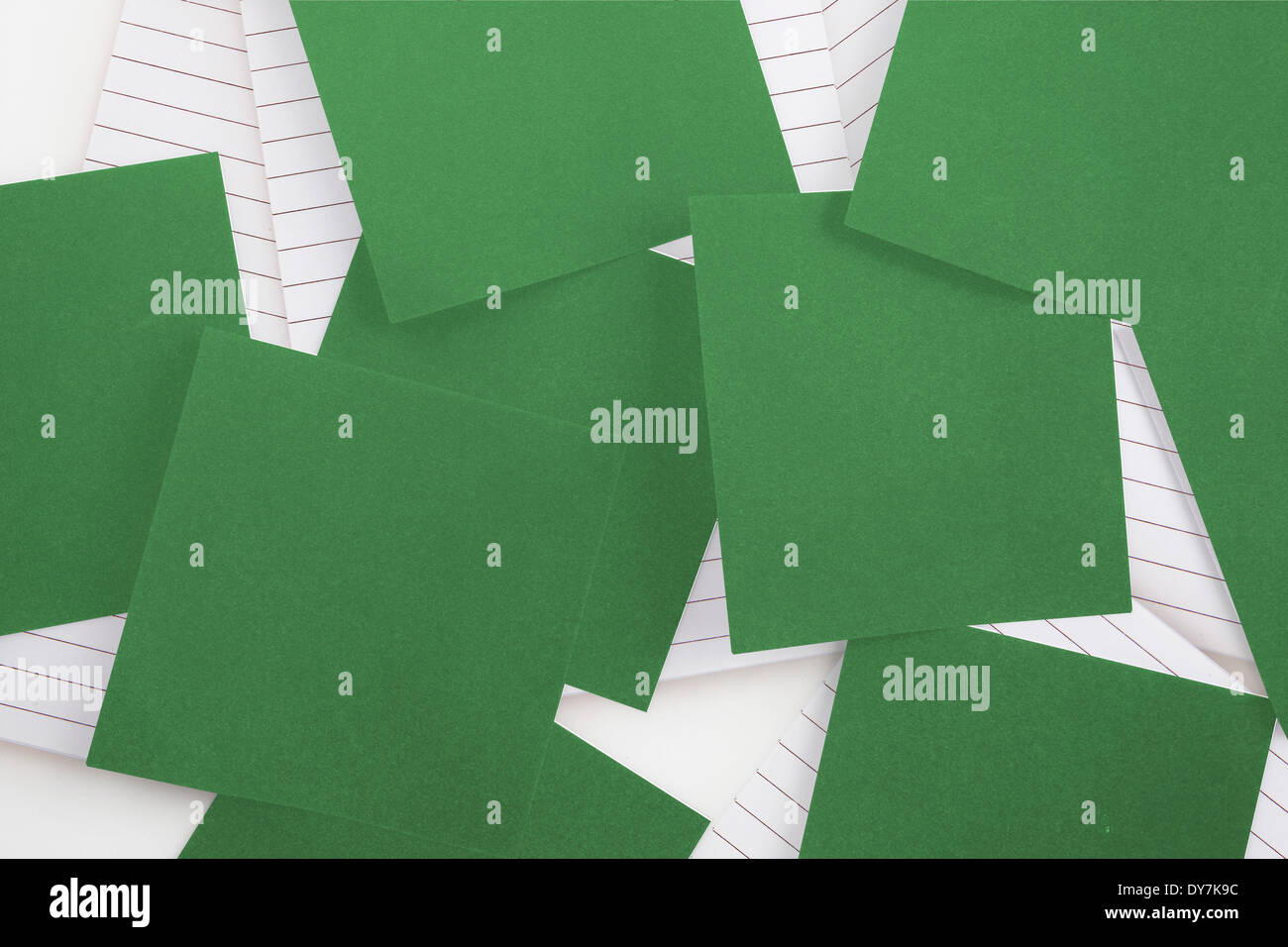Green paper strewn over notepad Stock Photo