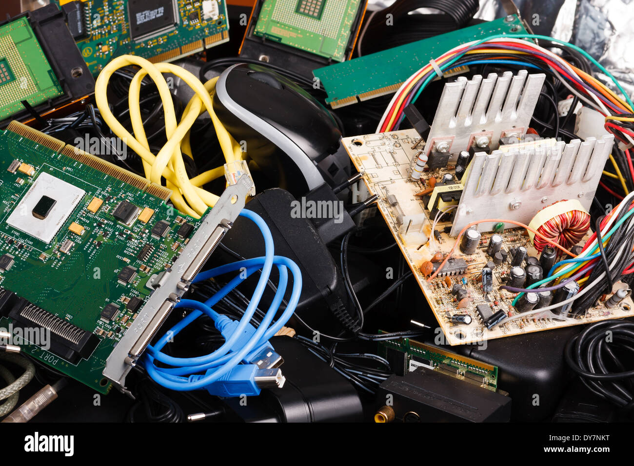 Old power supply, cables, hard drive in trash. Stock Photo