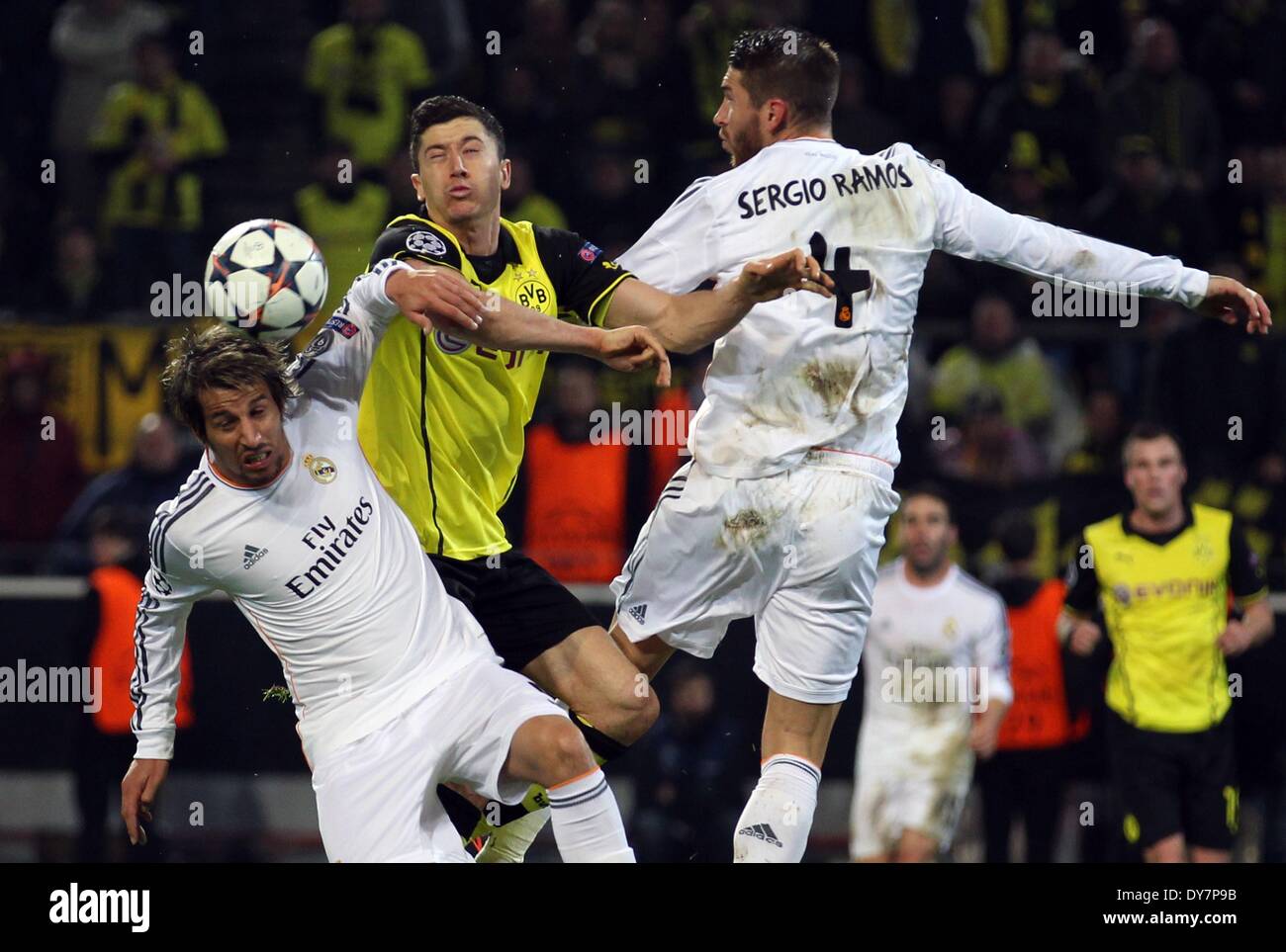 Dortmund, Germany. 08th Apr, 2014. Dortmund's Robert Lewandowski (C) in action against Madrid's Fabio Coentrao (L) and Sergio Ramos (R) during the UEFA Champions League quarter-final second leg soccer match between Borussia Dortmund and Real Madrid at the BVB stadium in Dortmund, Germany, 08 April 2014. Real lost 2-0 in Dortmund, on a first-half brace from Marco Reus, but scraped through on a 3-2 aggregate thanks to winning the first leg 3-0. Photo: Friso Gentsch/dpa/Alamy Live News Stock Photo
