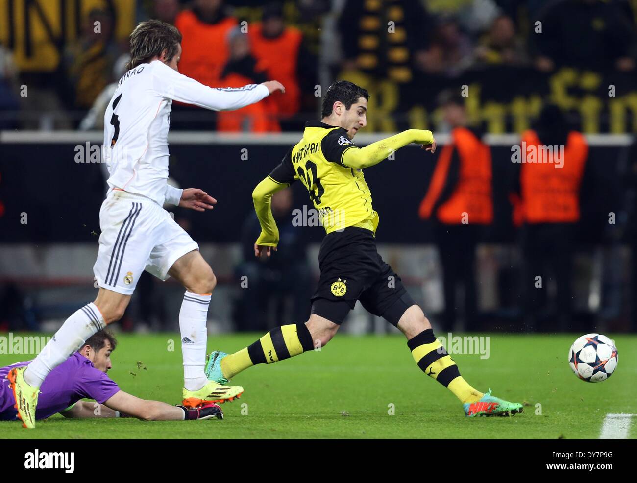Dortmund, Germany. 08th Apr, 2014. Dortmund's Henrikh Mkhitaryan (R) in action against Madrid's Iker Casillas (L) and Fabio Coentrao (C) during the UEFA Champions League quarter-final second leg soccer match between Borussia Dortmund and Real Madrid at the BVB stadium in Dortmund, Germany, 08 April 2014. Real lost 2-0 in Dortmund, on a first-half brace from Marco Reus, but scraped through on a 3-2 aggregate thanks to winning the first leg 3-0. Photo: Friso Gentsch/dpa/Alamy Live News Stock Photo