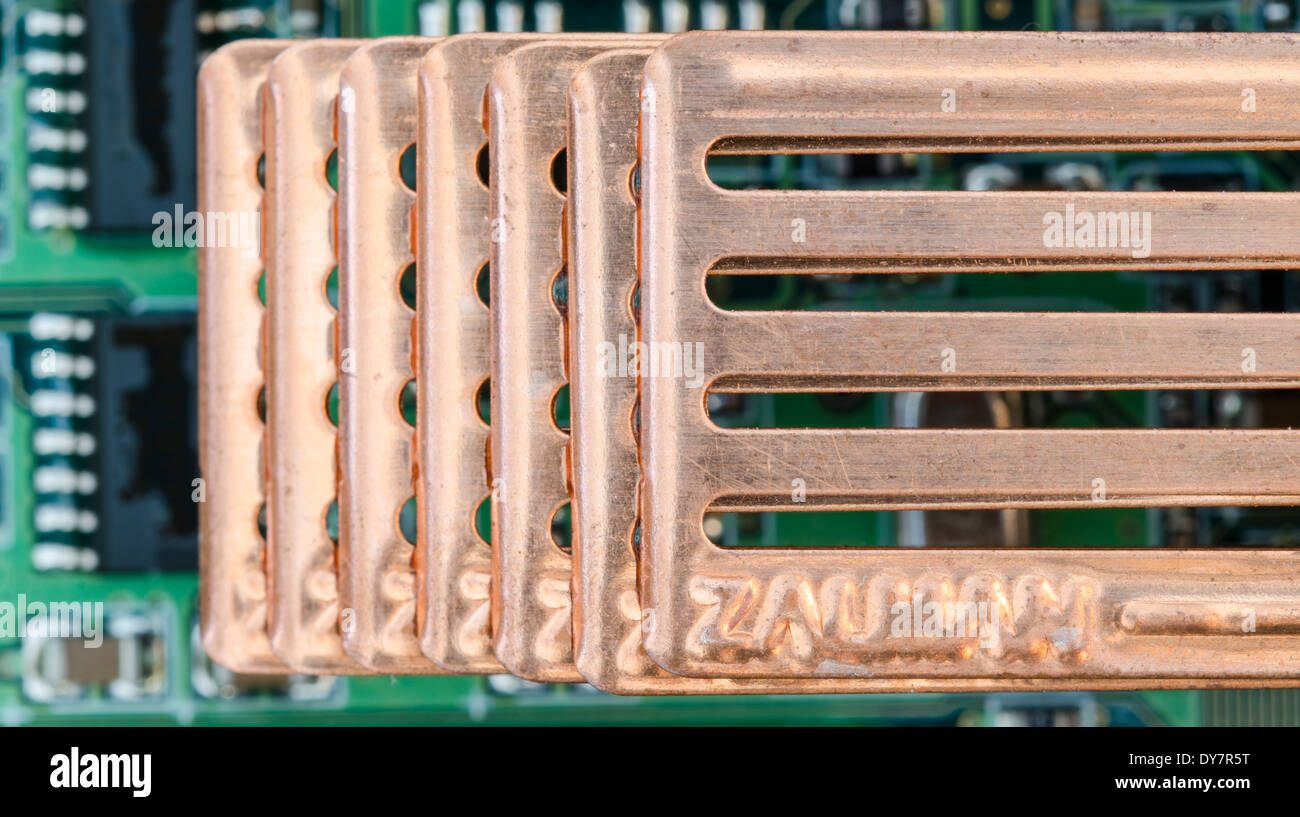 Metal heatsink mounted on an electronic circuit board. Stock Photo