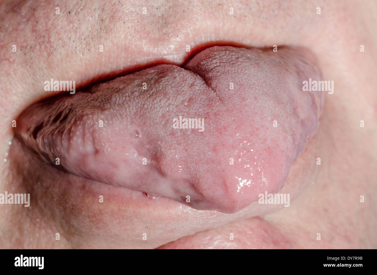 Tongue sticking out on a white mans face. Stock Photo