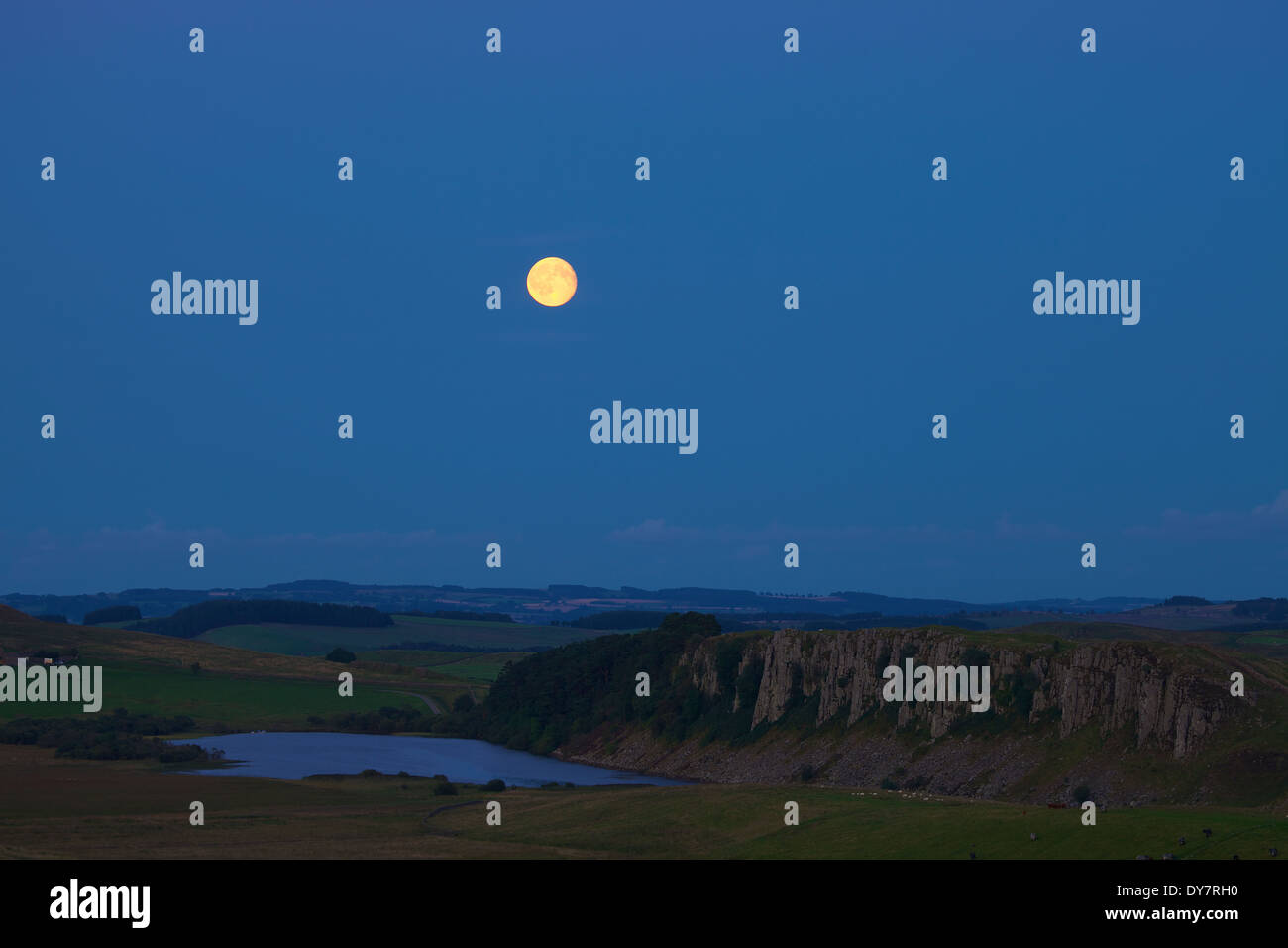 Moon over Hot Bank then Highshield Crags and Crag Lough from Steel Rigg, Hadrian's Wall, Northumbria, England, United Kingdom Stock Photo