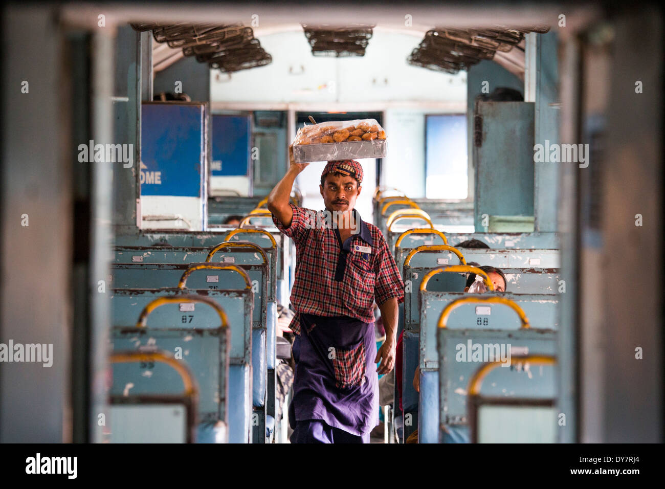 Snack vendor on a train in Kerala, India Stock Photo