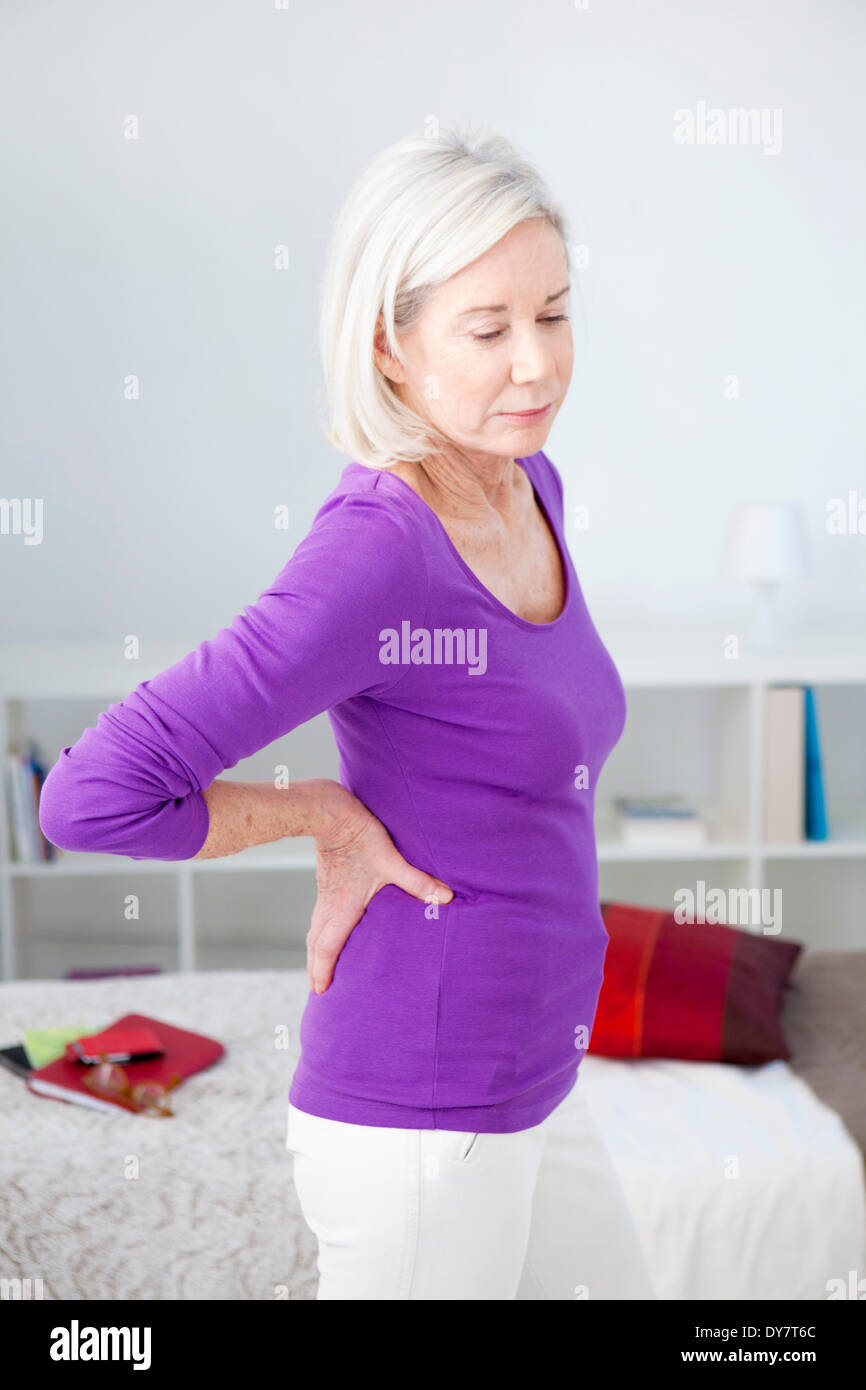 Lower back pain in elderly person Stock Photo