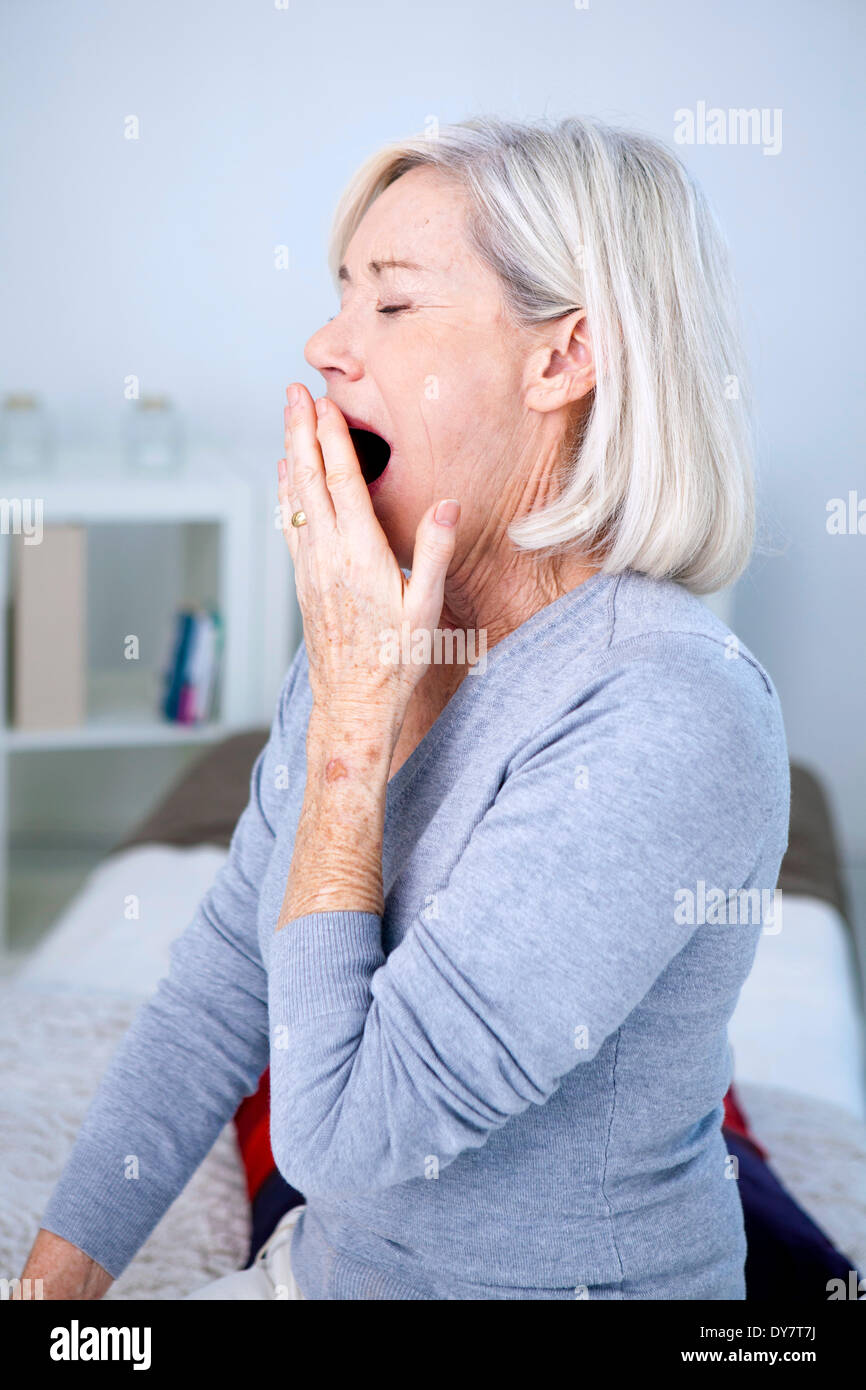 Elderly person yawning Stock Photo