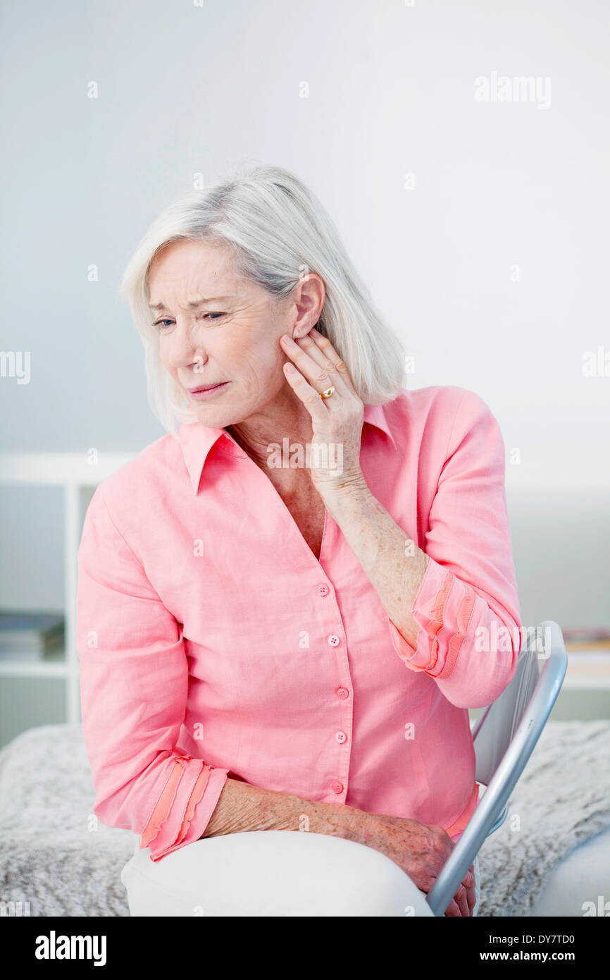 Ear pain in an elderly person Stock Photo