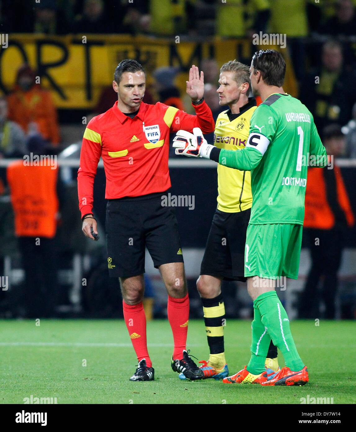 Referee Damir Skomina (L) discuss with Oliver Kirch (M) and goalkeeper Roman Weidenfeller during the UEFA Champions League quarter final match between Borussia Dortmund and Real Madrid, Signal Iduna Park in Dortmund on April 08, 2014. Stock Photo