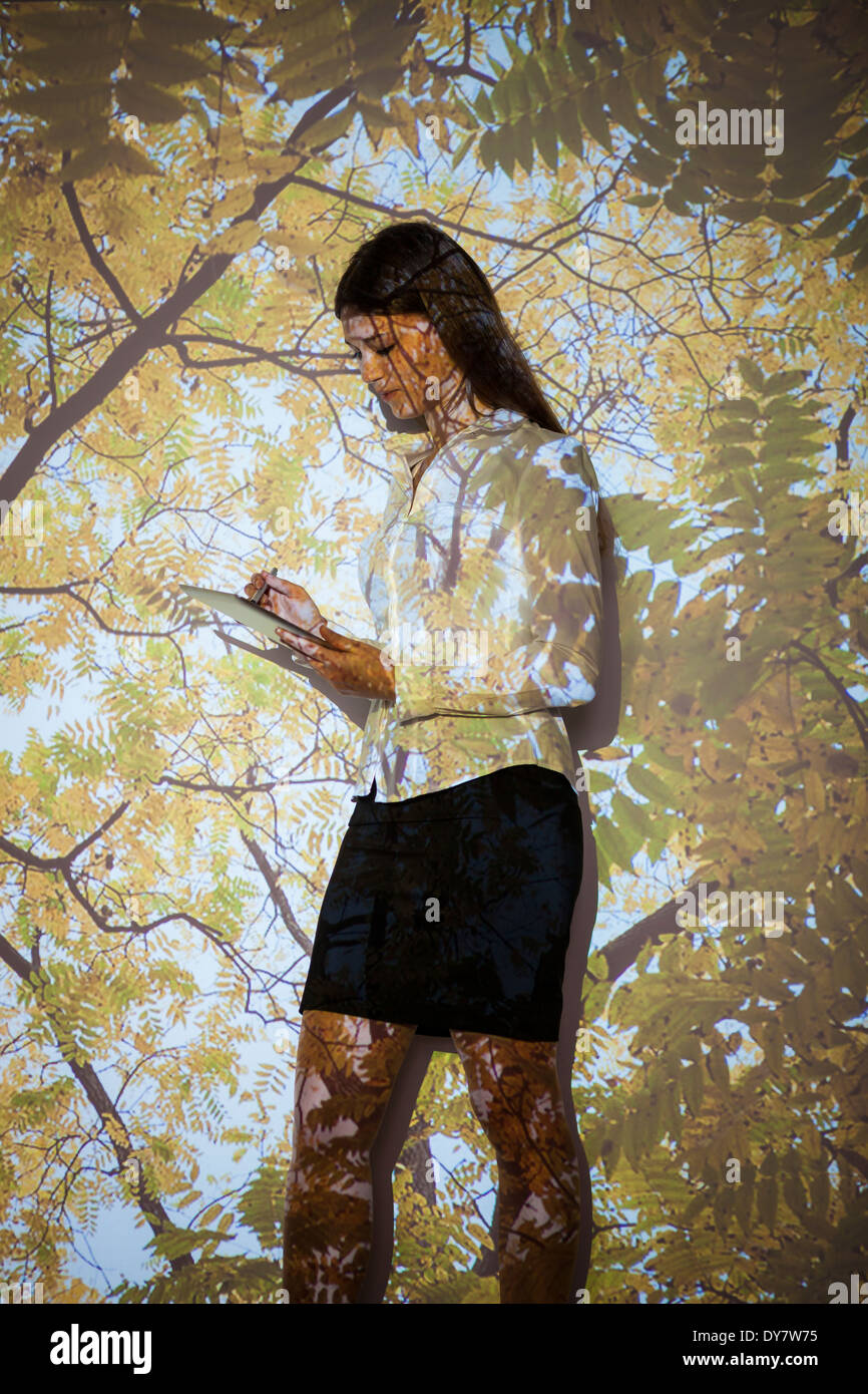 Young woman in nature  projection using digital tablet Stock Photo