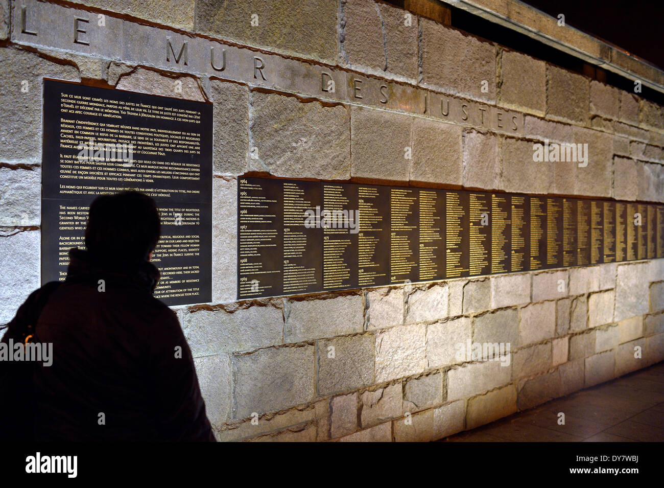 Person standing in front of the Le Mur de Justes plaque at the Memorial de la Shoah, central memorial to the Holocaust Stock Photo