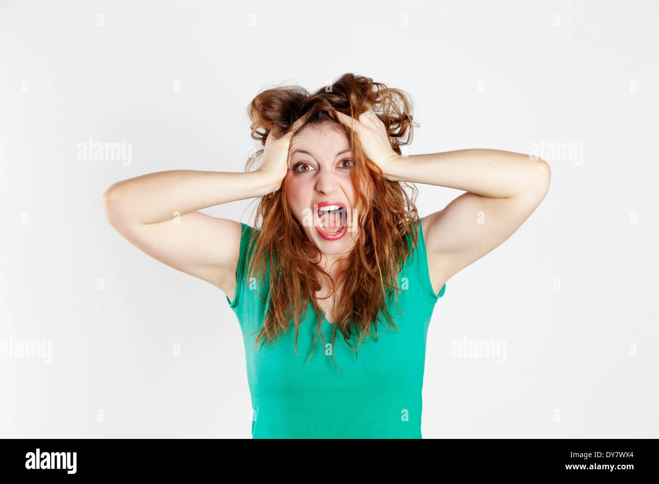 Desperate young woman tearing her hair Stock Photo