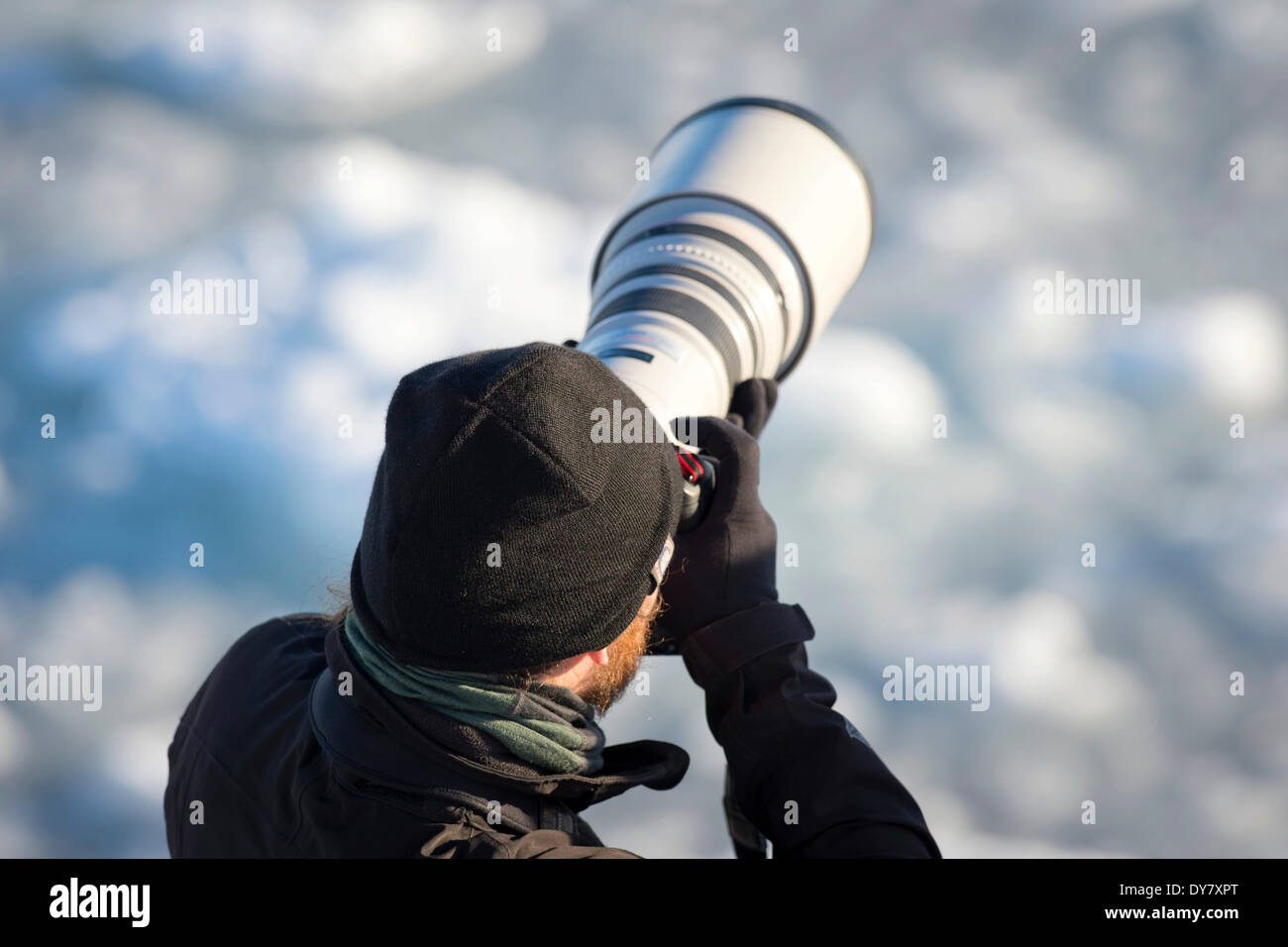 Photographer with a telephoto lens, Spitsbergen Island, Svalbard Archipelago, Svalbard and Jan Mayen, Norway Stock Photo