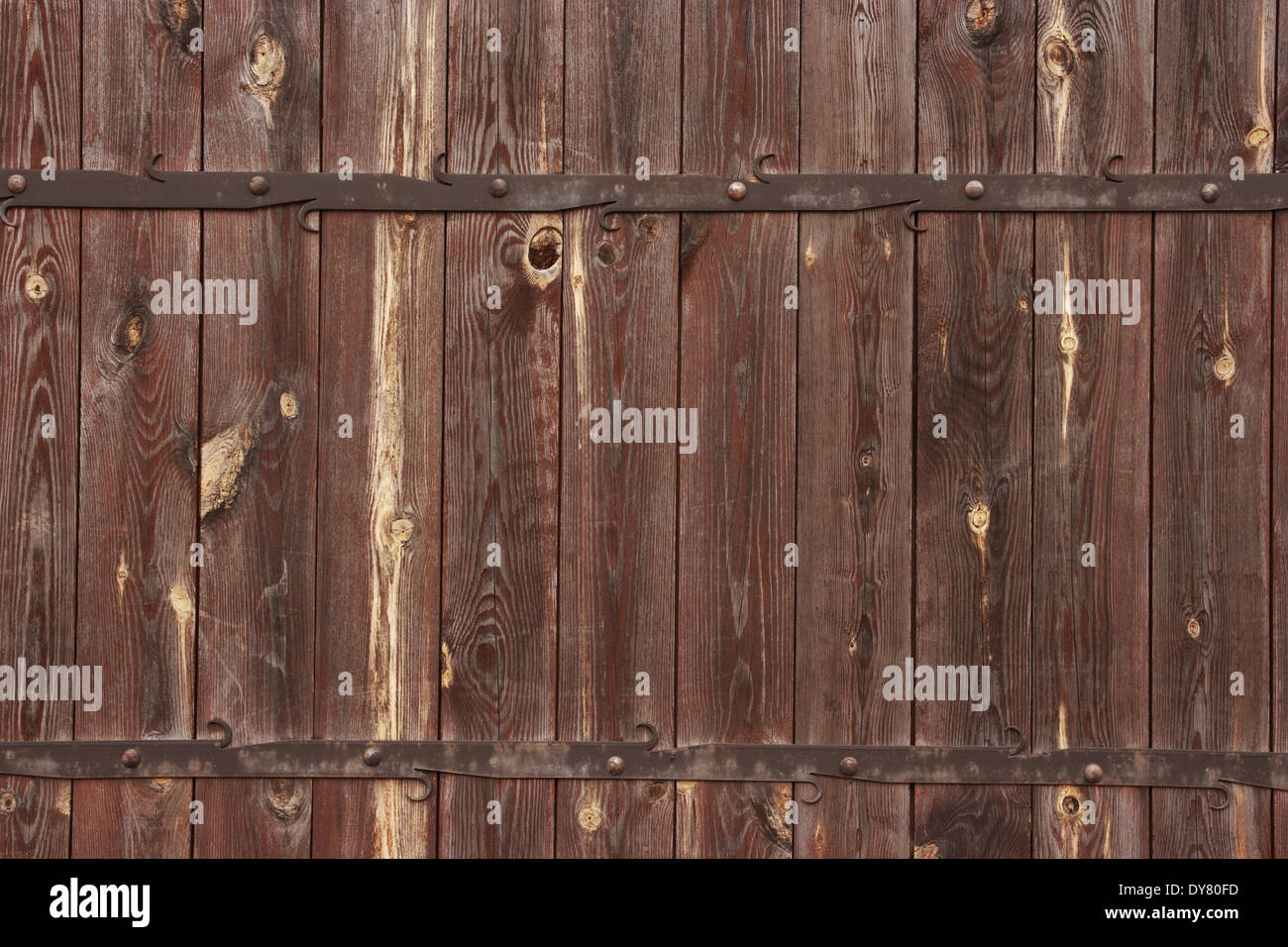Wooden background with metal decorations. Wooden gate with forged metal decorations. Stock Photo