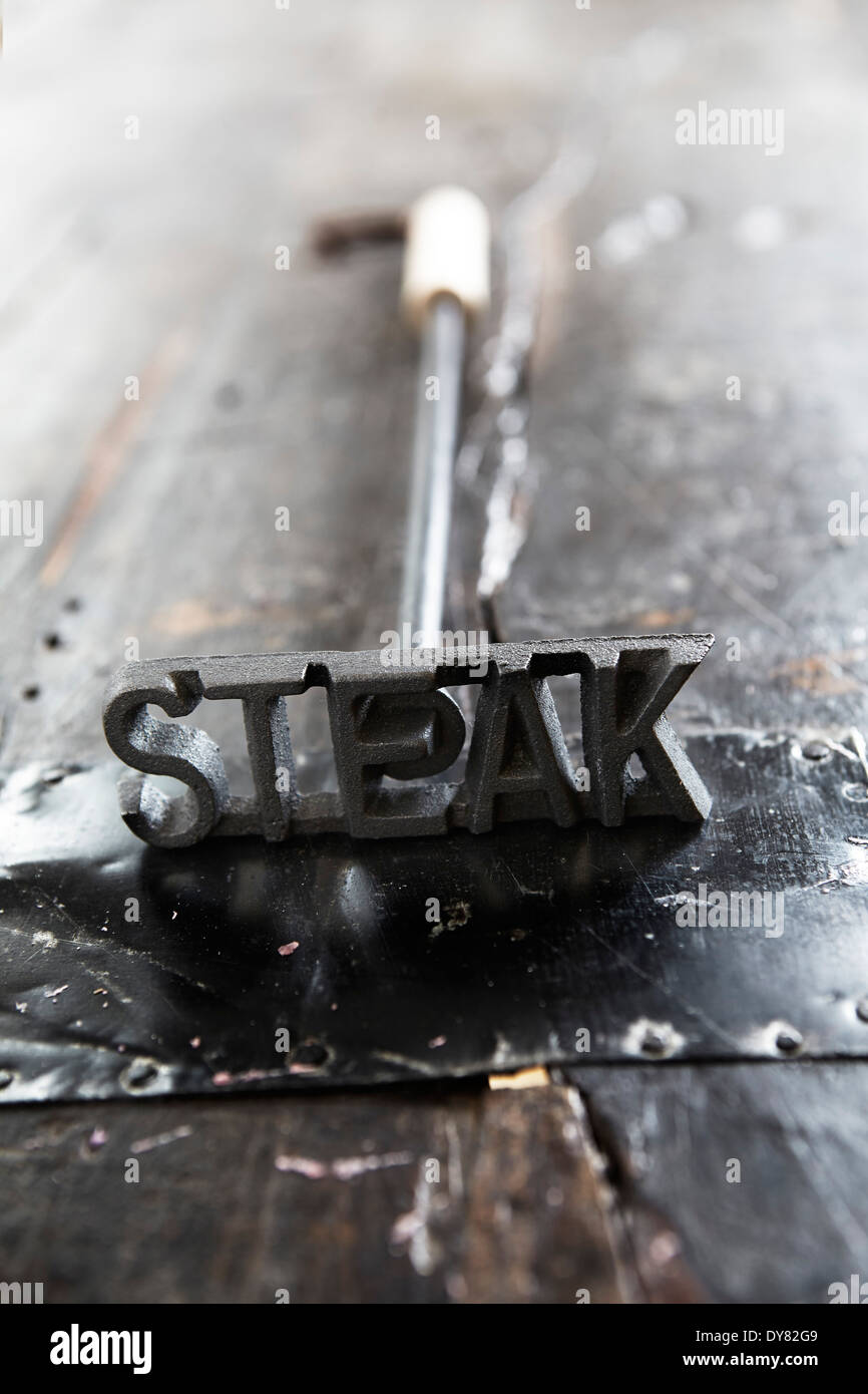 Steak written on meat tenderizer Stock Photo