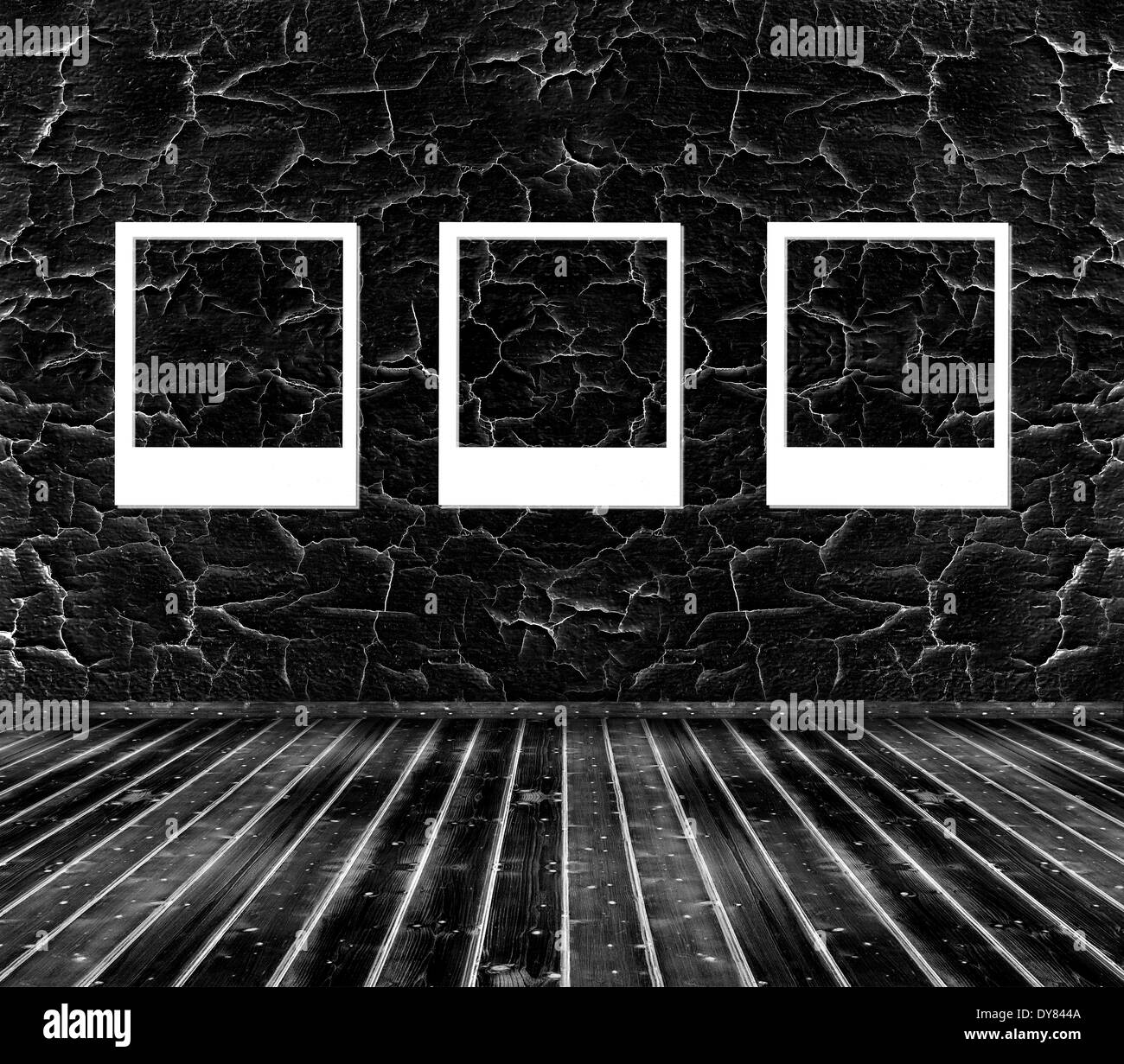 three picture frames on black cracked wall and wooden floor Stock Photo Alamy