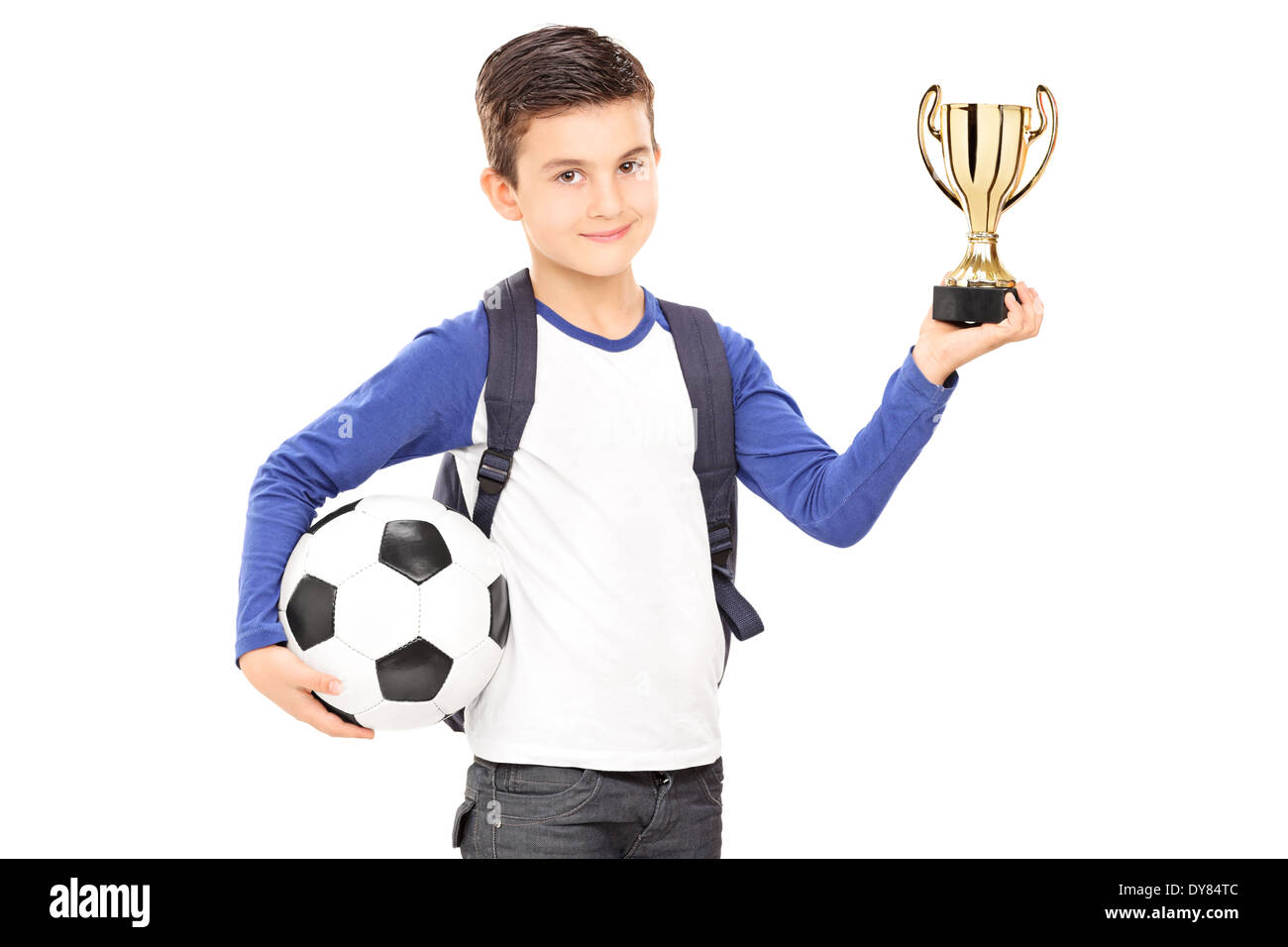 Little schoolboy holding football and a trophy Stock Photo