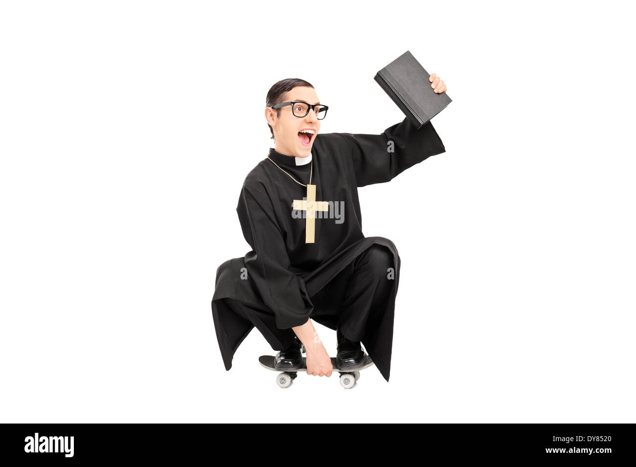 Male priest riding a small skateboard Stock Photo