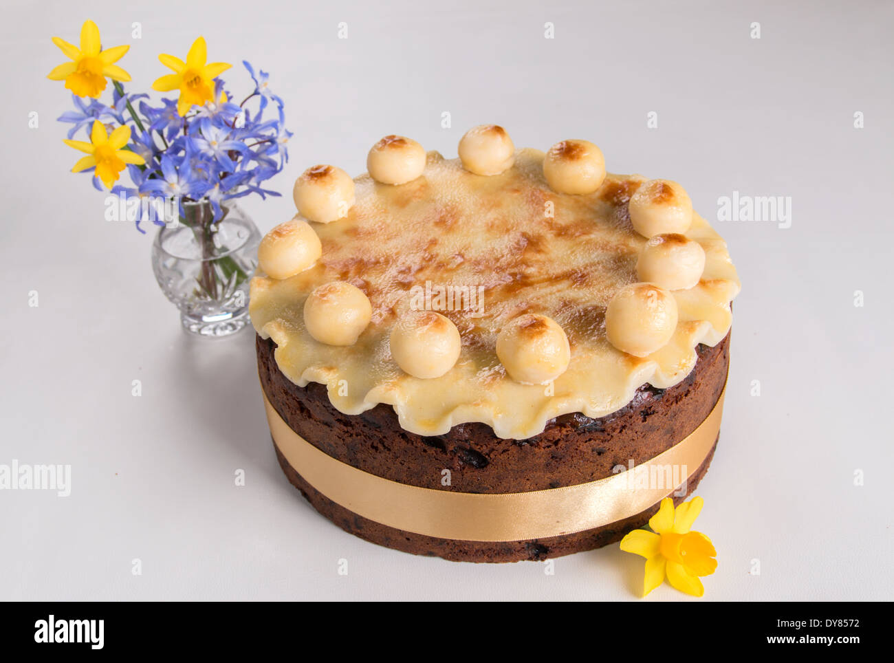 Simnel cake on a light background with fluted marzipan a yellow ribbon  with 11 marzipan balls (25 of 35) Stock Photo