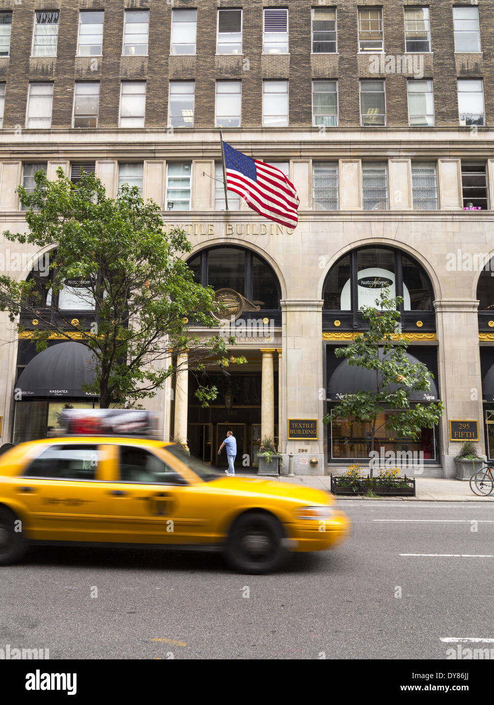 The Textile Building 295 Fifth Avenue speeding yellow taxi cab New York USA Stock Photo