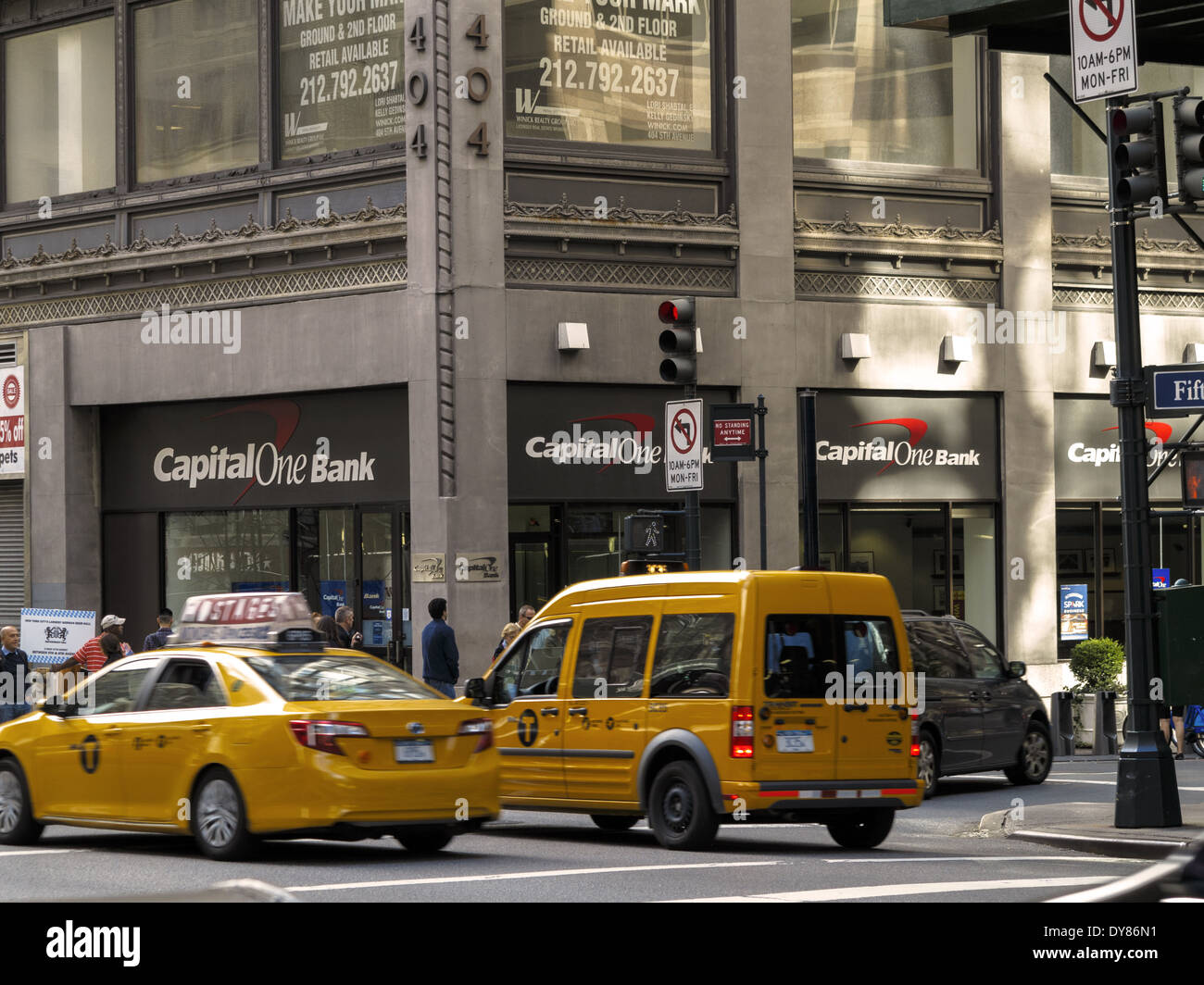 Capital One Bank and yellow taxi cab Fifth Avenue New York USA Stock Photo