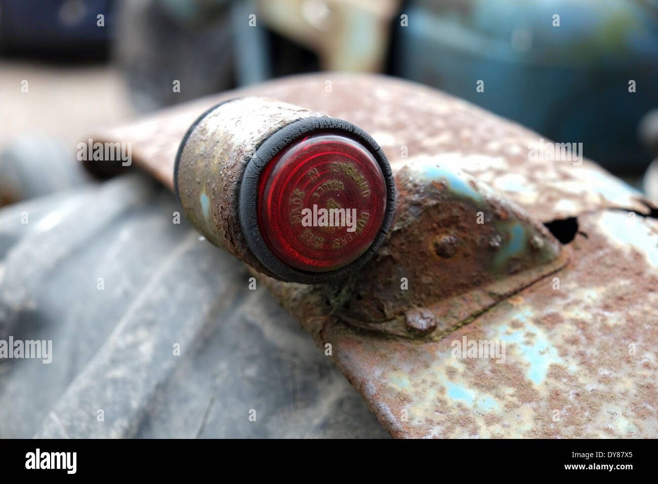 Small light on the rear mudguard of an abandoned tractor Stock Photo