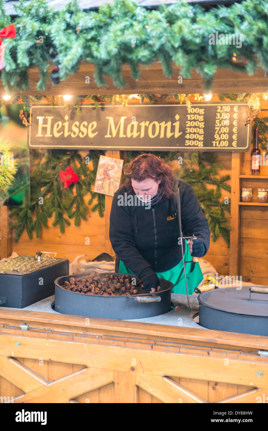 Woman roasting chestnuts (marone) at Christmas Market, Bamberg, Germany Stock Photo