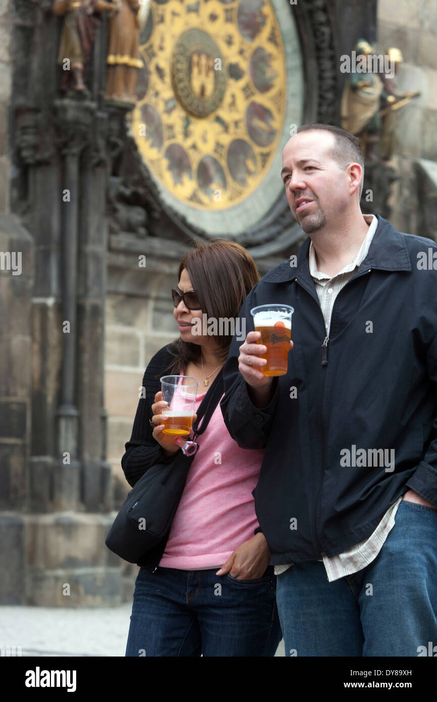 Prague tourists drinking beer bellow Astronomical Clock Old Town Square, Prague couple Czech Republic people Stock Photo