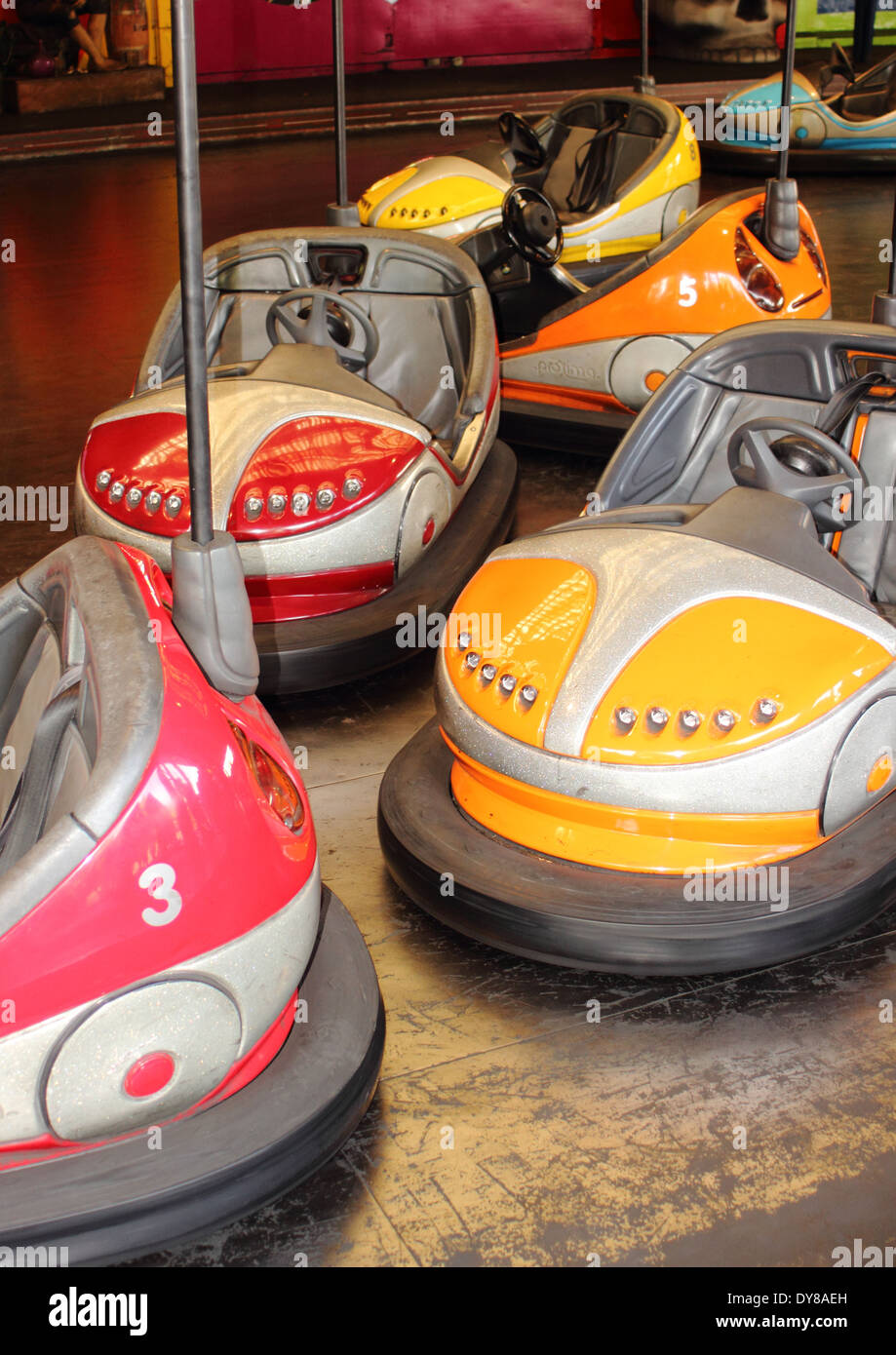 Empty red and orange bumper cars at fairground Stock Photo