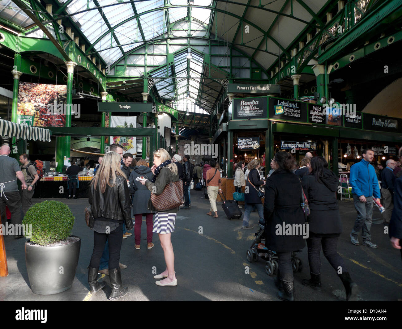 Intside view of people eating and at food stalls in Borough Market, Southwark London, UK  KATHY DEWITT Stock Photo