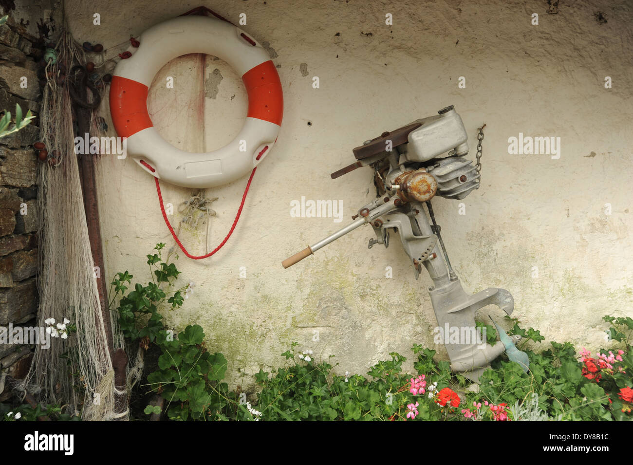 Life preserver, engine, outboard, outboard motor, fishing net, wall, Italy, Piemont, Borromeo Stock Photo