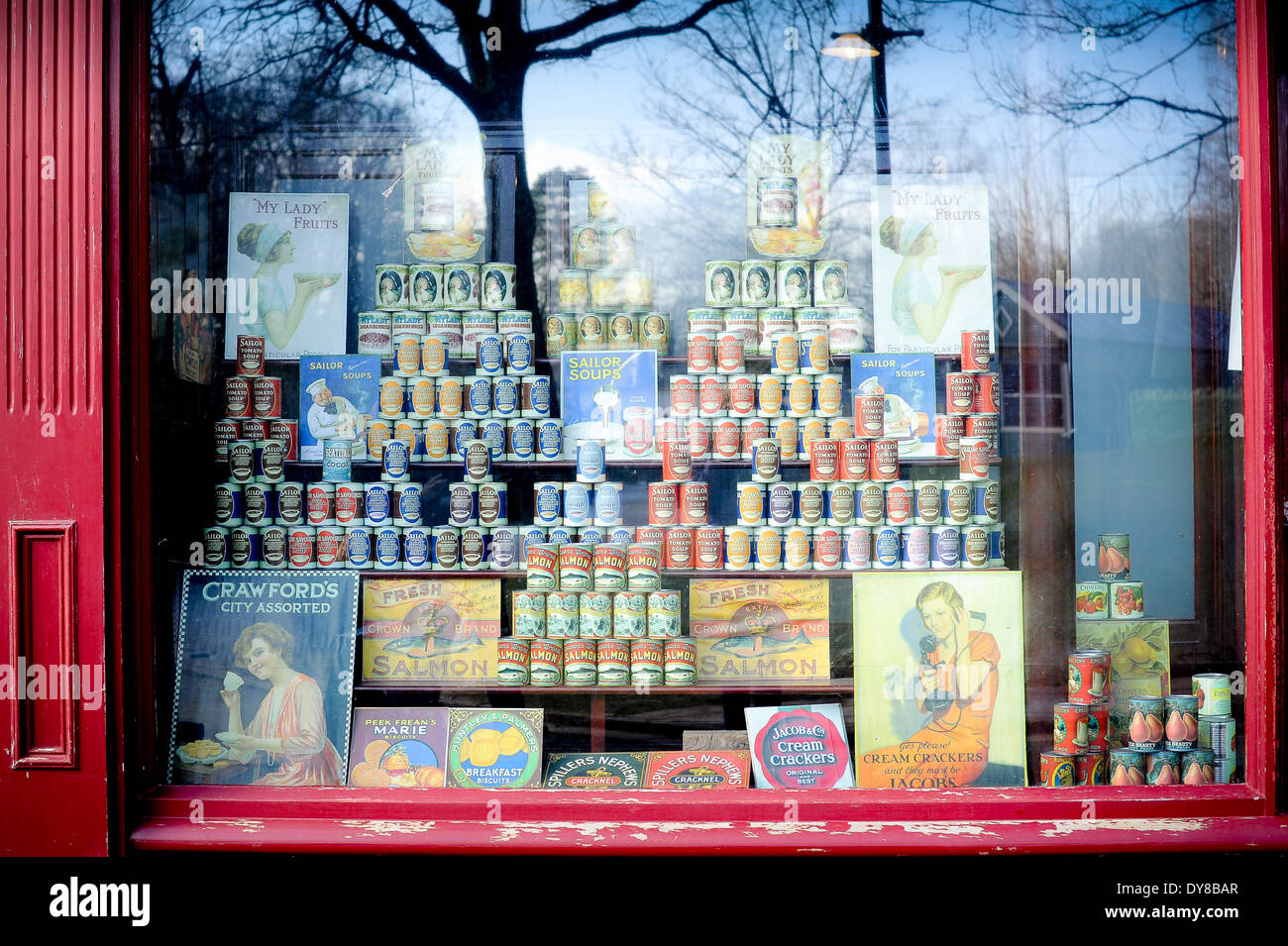 Tinned, canned food  and advertising posters in 1930's and 1940's shop window and shopfront Stock Photo