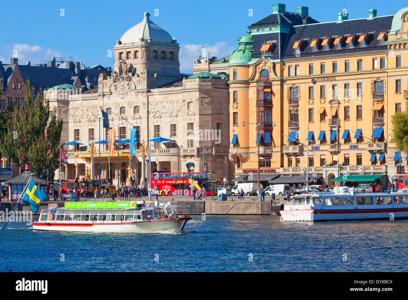 boat capital cities city day Dramaten Europe ferry flag harbour Nordic Nybroviken outdoors people Royal Dramatic Theatre Sc Stock Photo