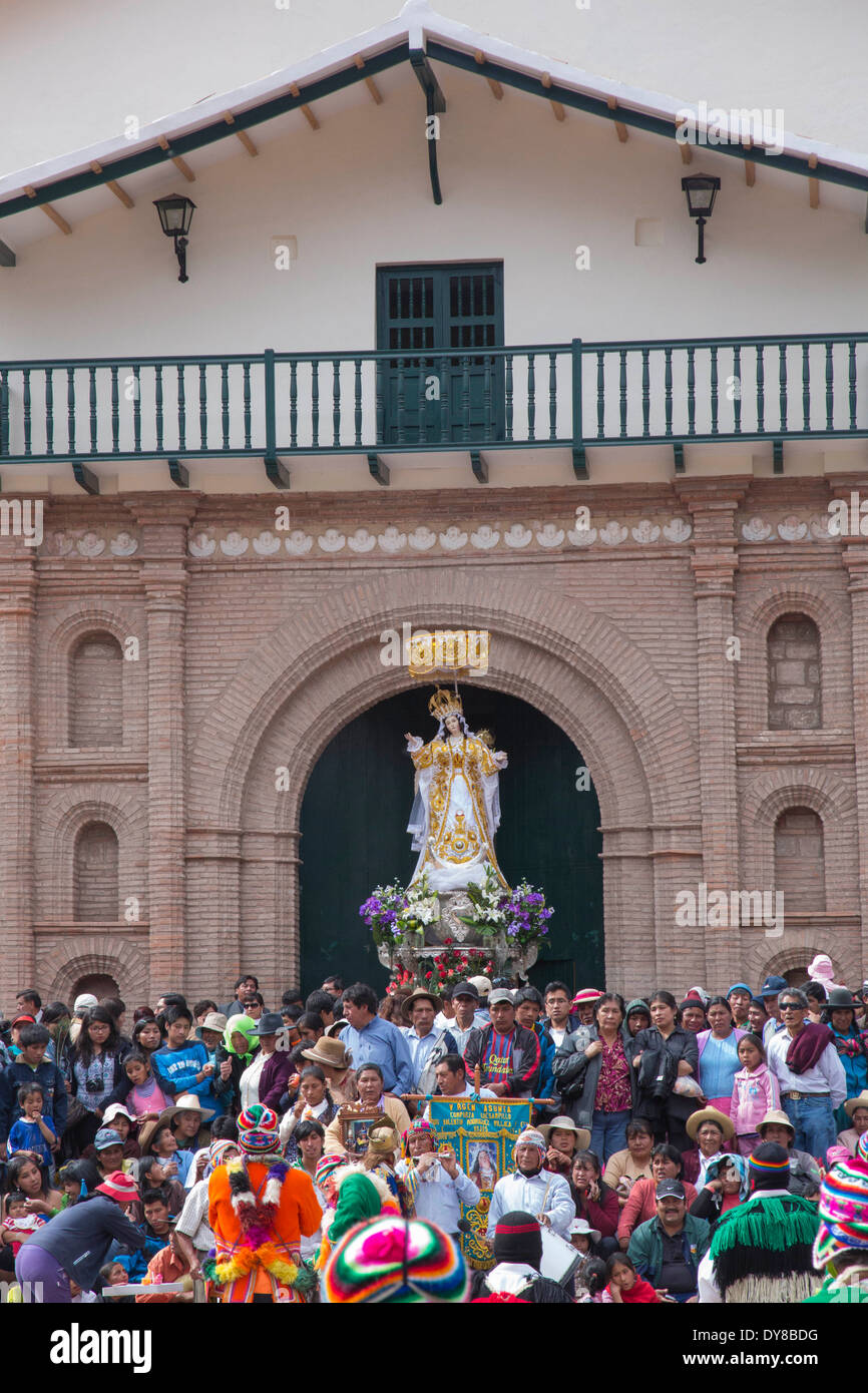 Peru, Calca, dancers and village men in front of church with Virgin Mary statue during Assumption of the Virgin festival Stock Photo