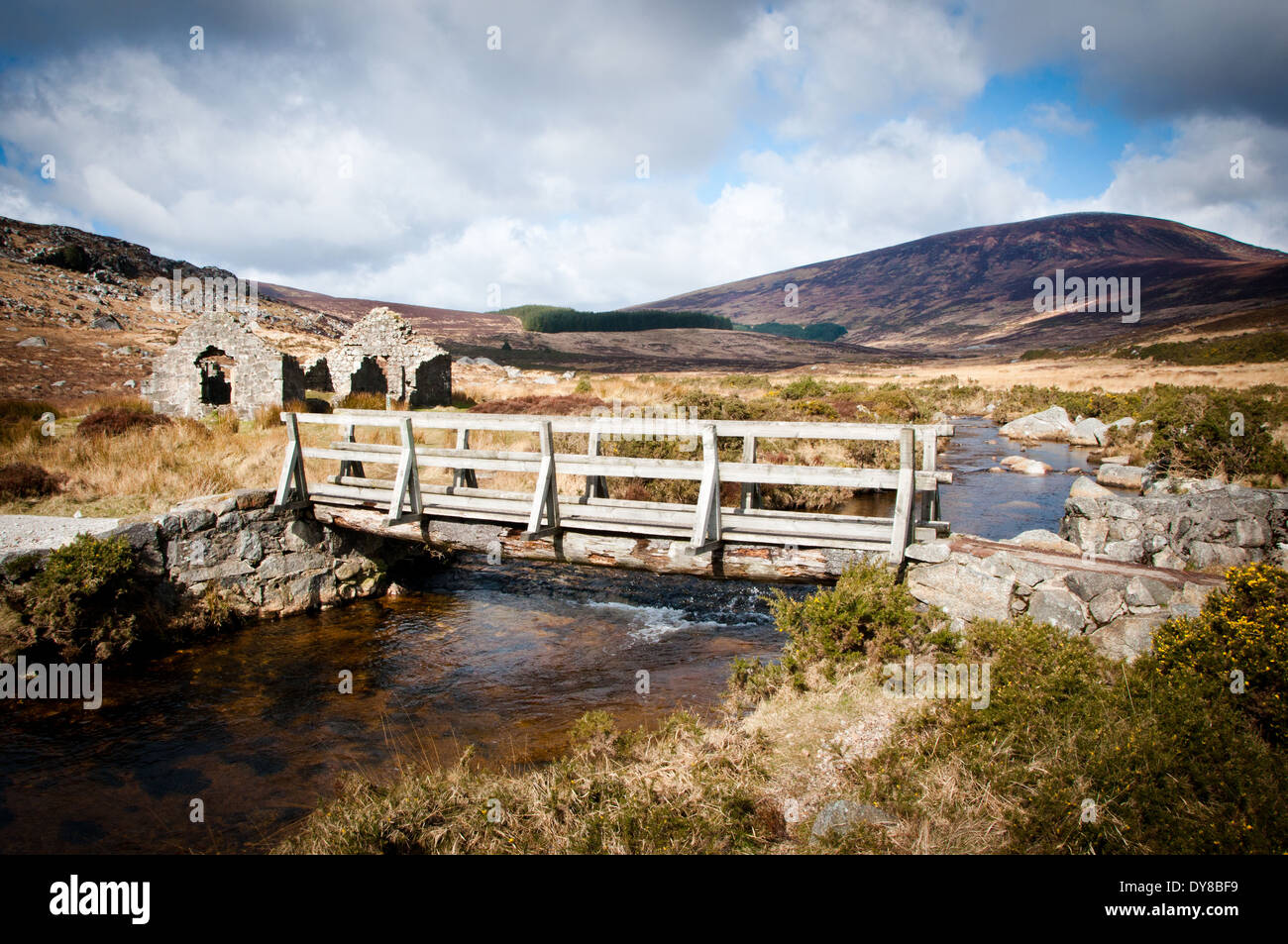 Wooden Bridge and Ruins at Glendasan River in Wicklow mountains Ireland Stock Photo