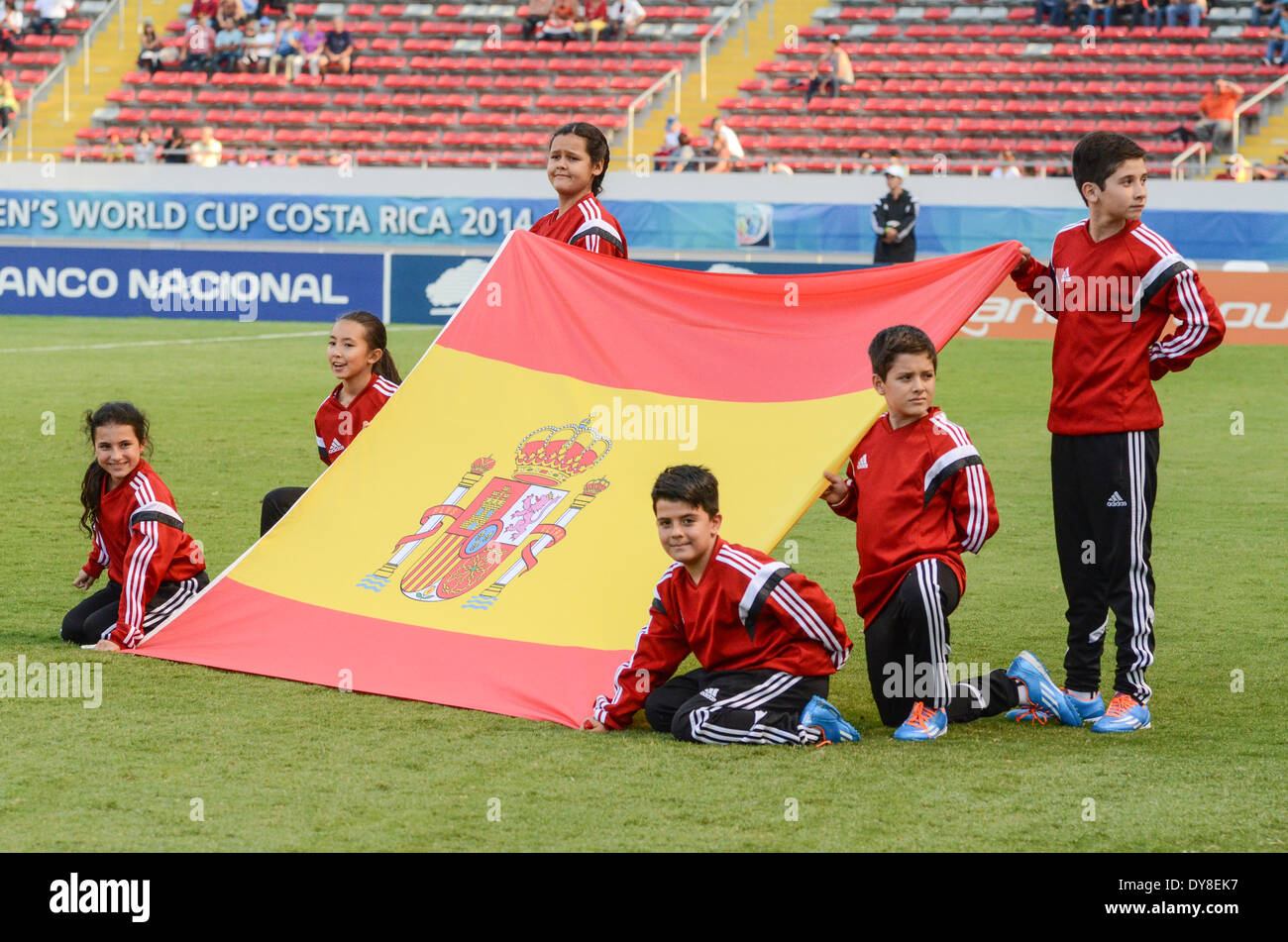 Children holding Spain flag in National Stadium pitch Stock Photo