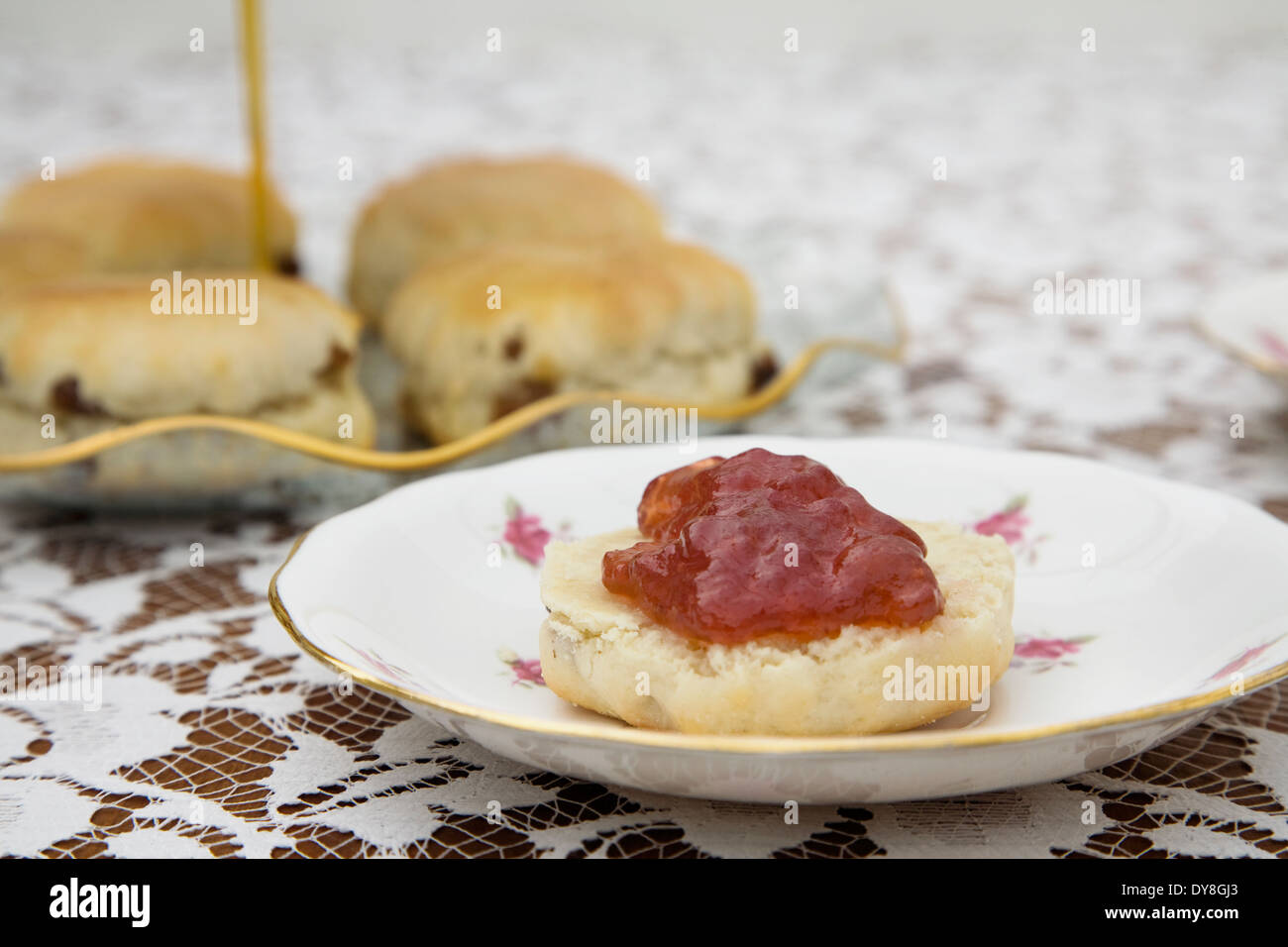 English Afternoon tea with Scones,Jam, vintage cake stand and flora tablecloth Stock Photo