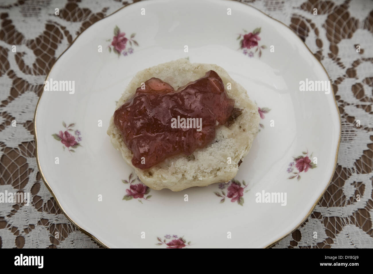 English Afternoon tea. Vintage plate with Scones and Jam on a flora tablecloth Stock Photo