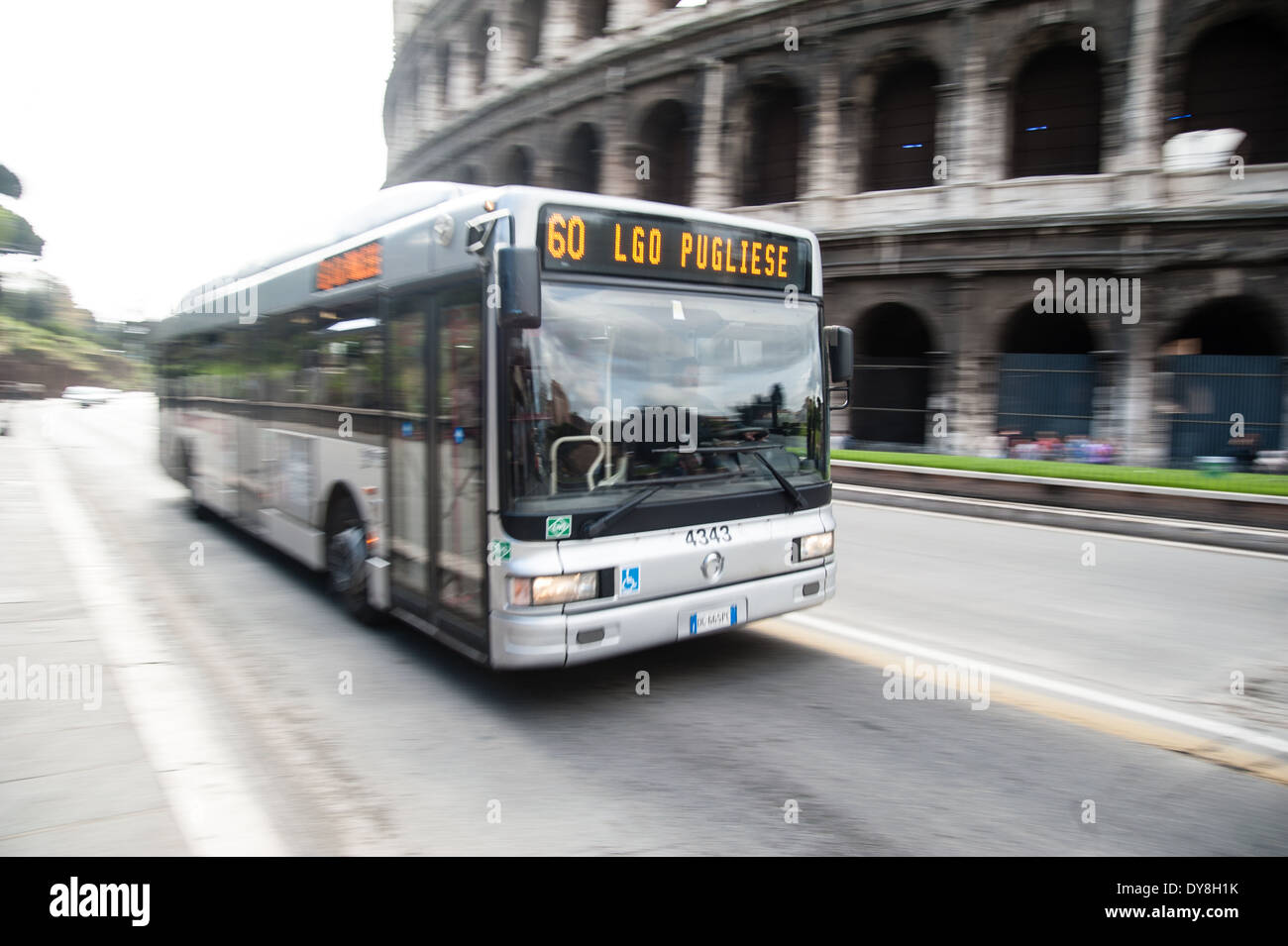 Bus passing the Coliseum. Slow shutter speed giving the impression of speed Stock Photo