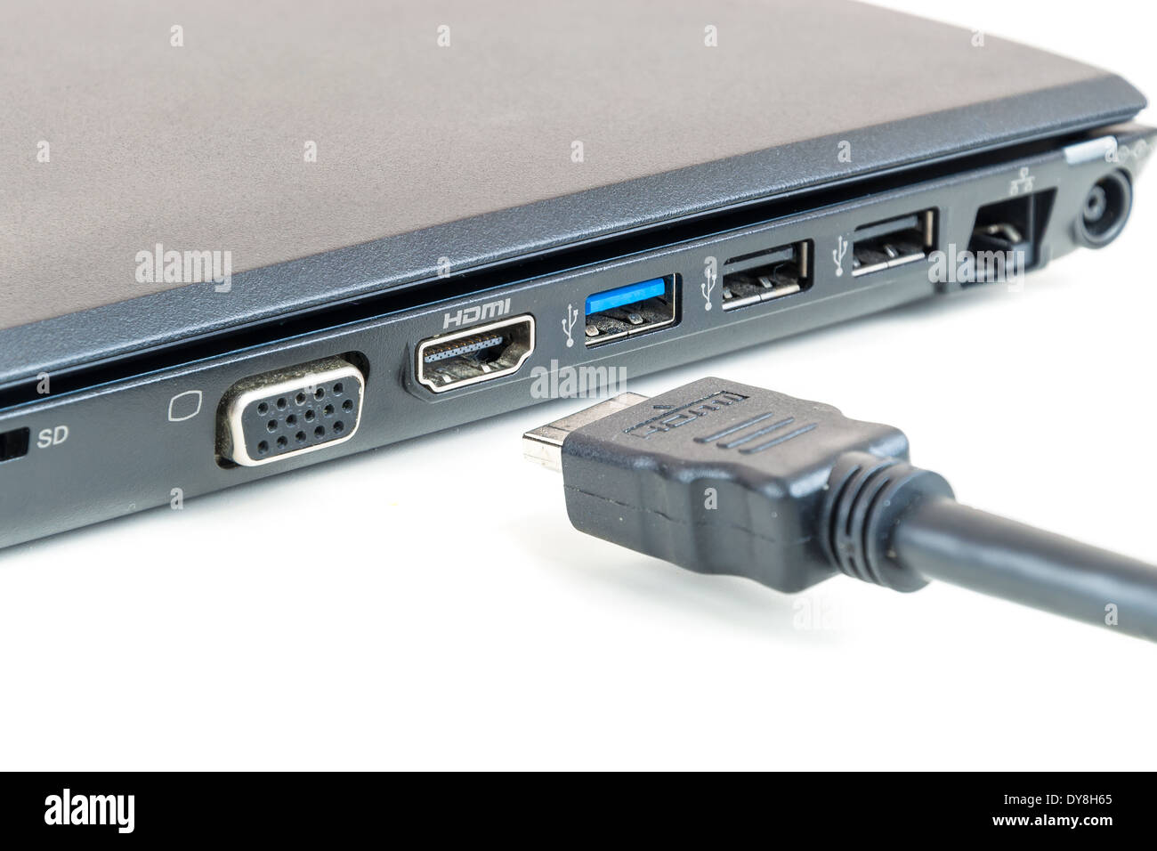 Plugging in modern HDMI cable to laptop Stock Photo