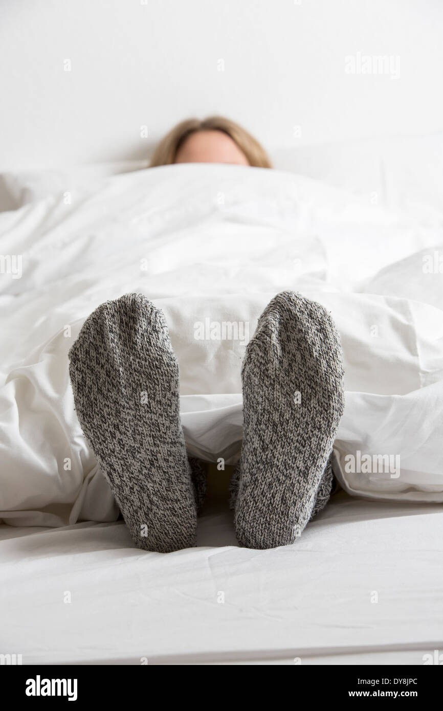Feet woman lying in bed hires stock photography and images Alamy