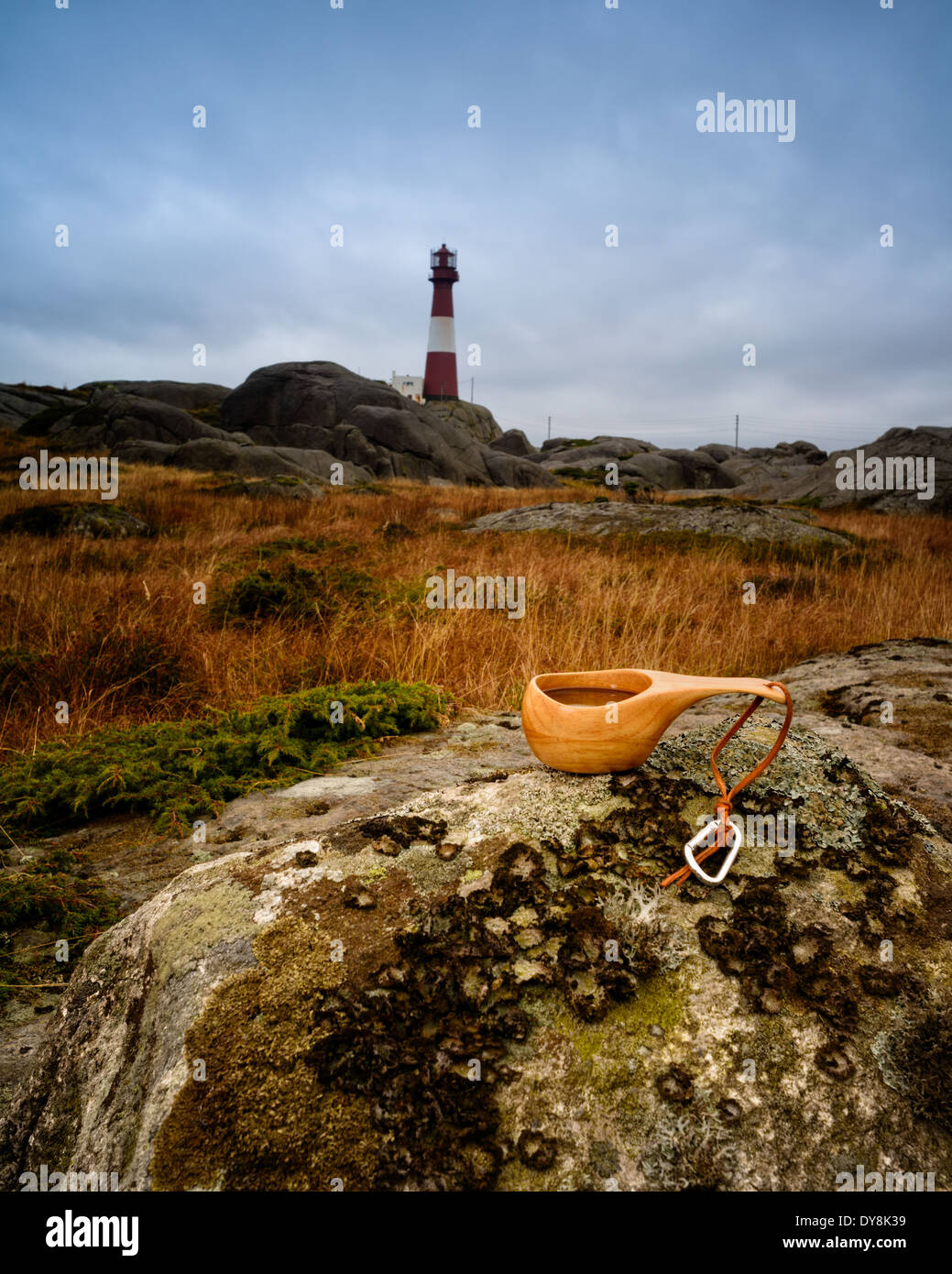 Savoring a cup of coffee with a view of Eigerøy lighthouse in the scenic backdrop of Rogaland, Norway. Stock Photo