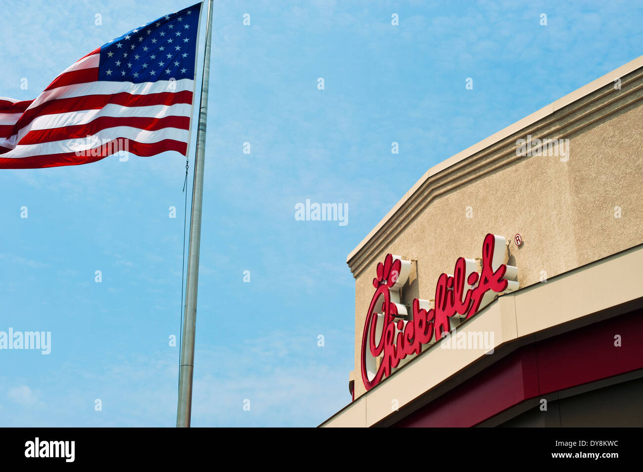 Chick-fil -a,  Chick Fil A restaurant sign with American flag Stock Photo