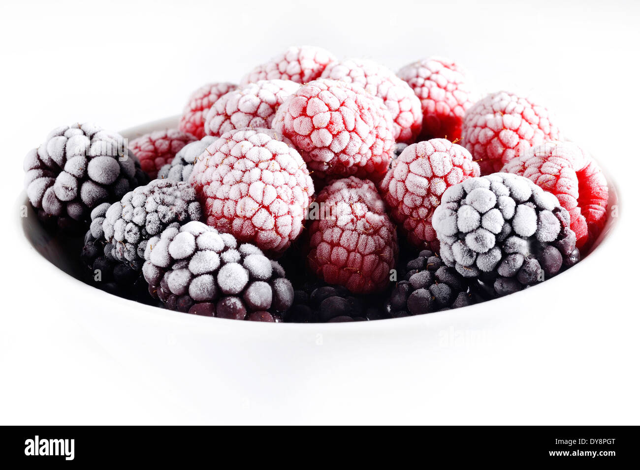 frozen raspberries and blackberries in white bowl Stock Photo Alamy