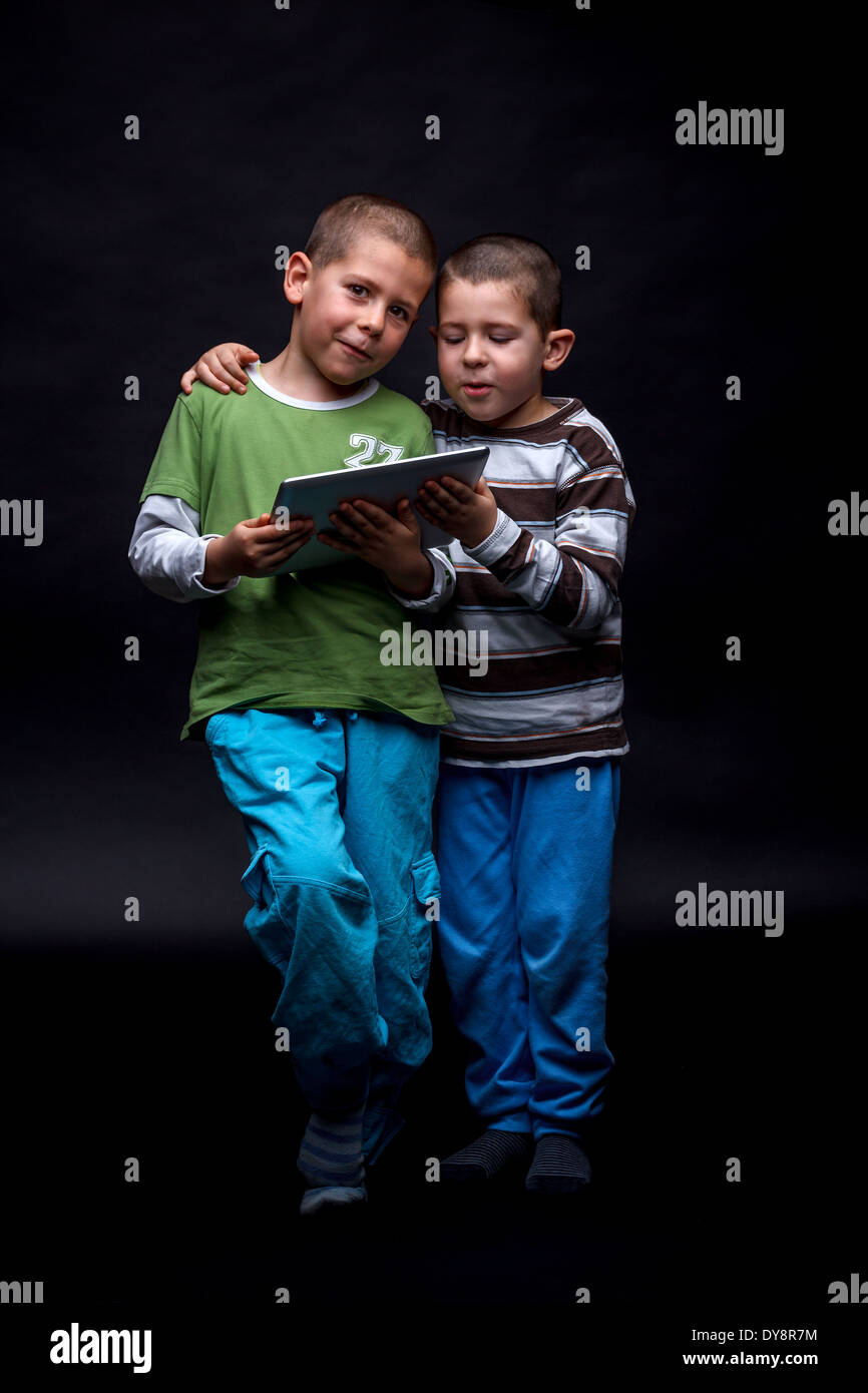Boys using electronic tablet Stock Photo